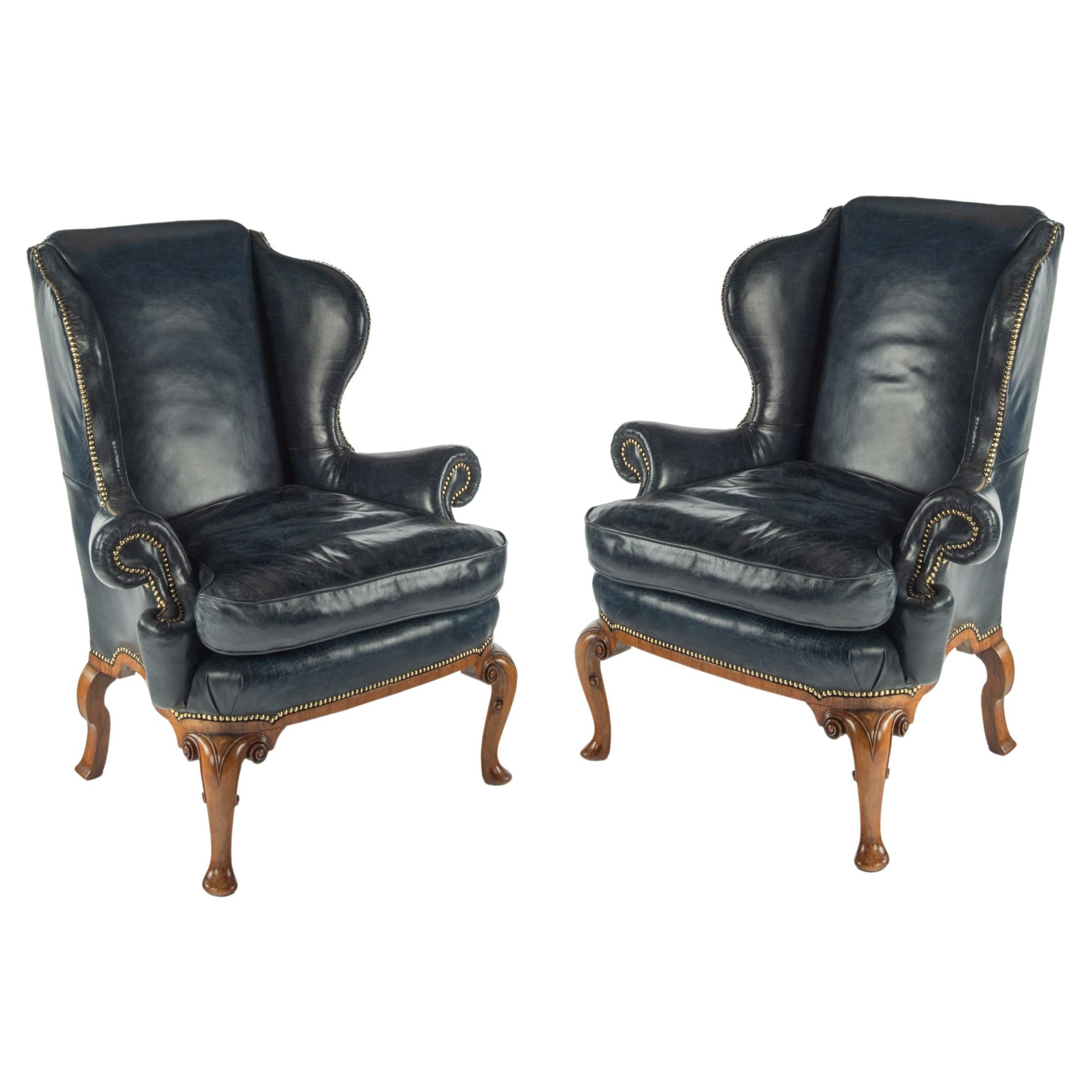 A pair of generous George I style walnut wing arm chairs