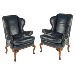 A pair of generous George I style walnut wing arm chairs