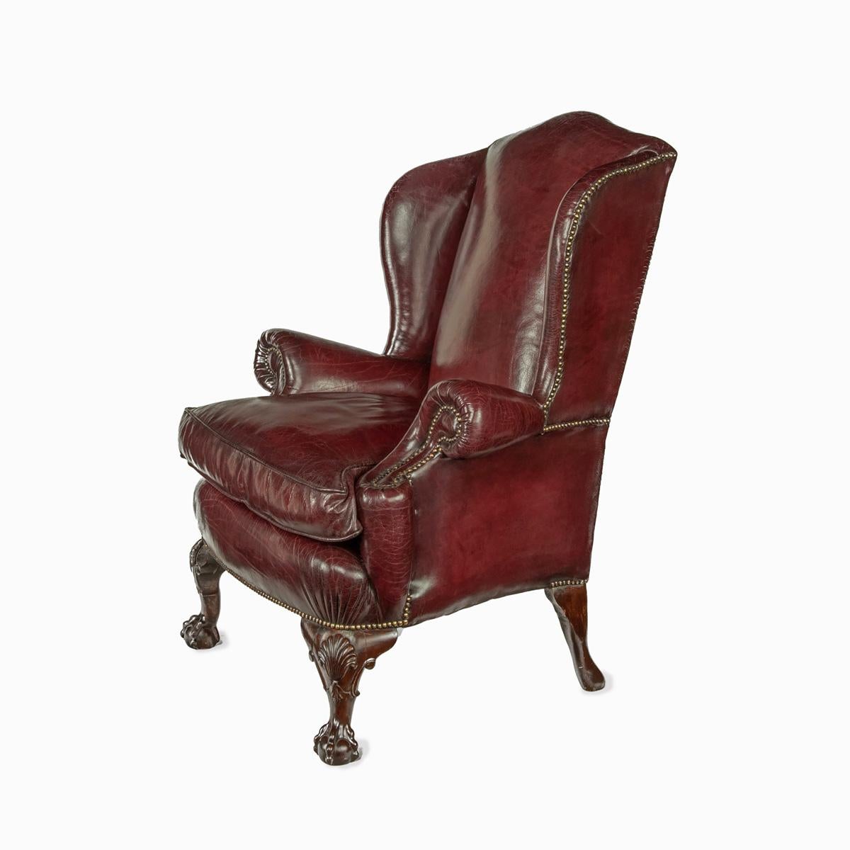 English A pair of generous mahogany wing armchairs with shell carved knees For Sale