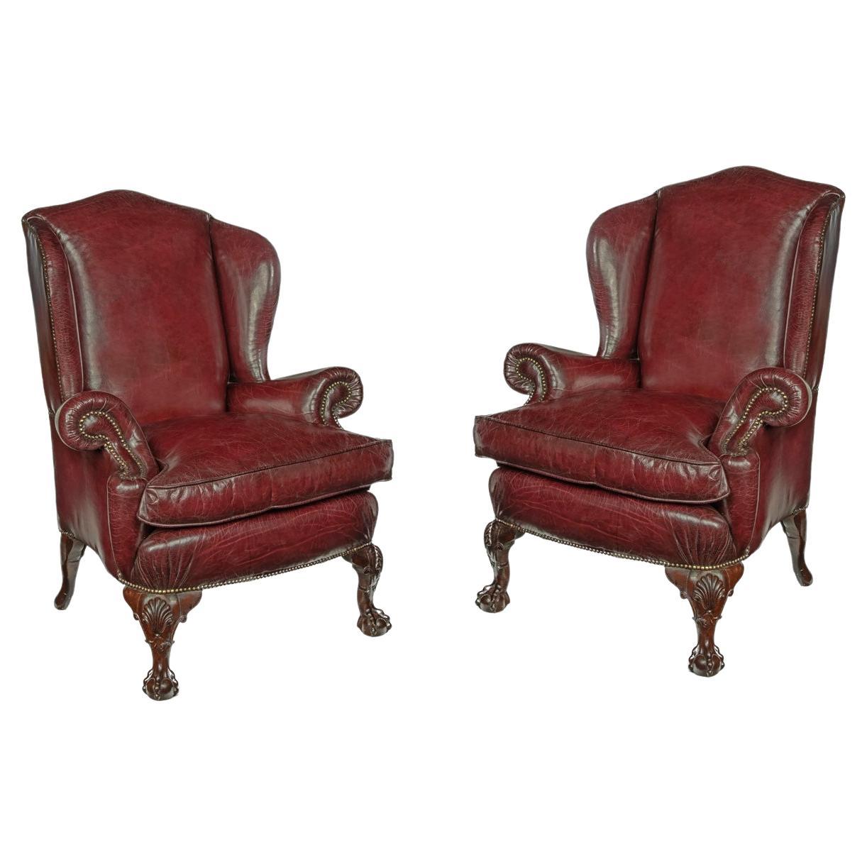 A pair of generous mahogany wing armchairs with shell carved knees For Sale
