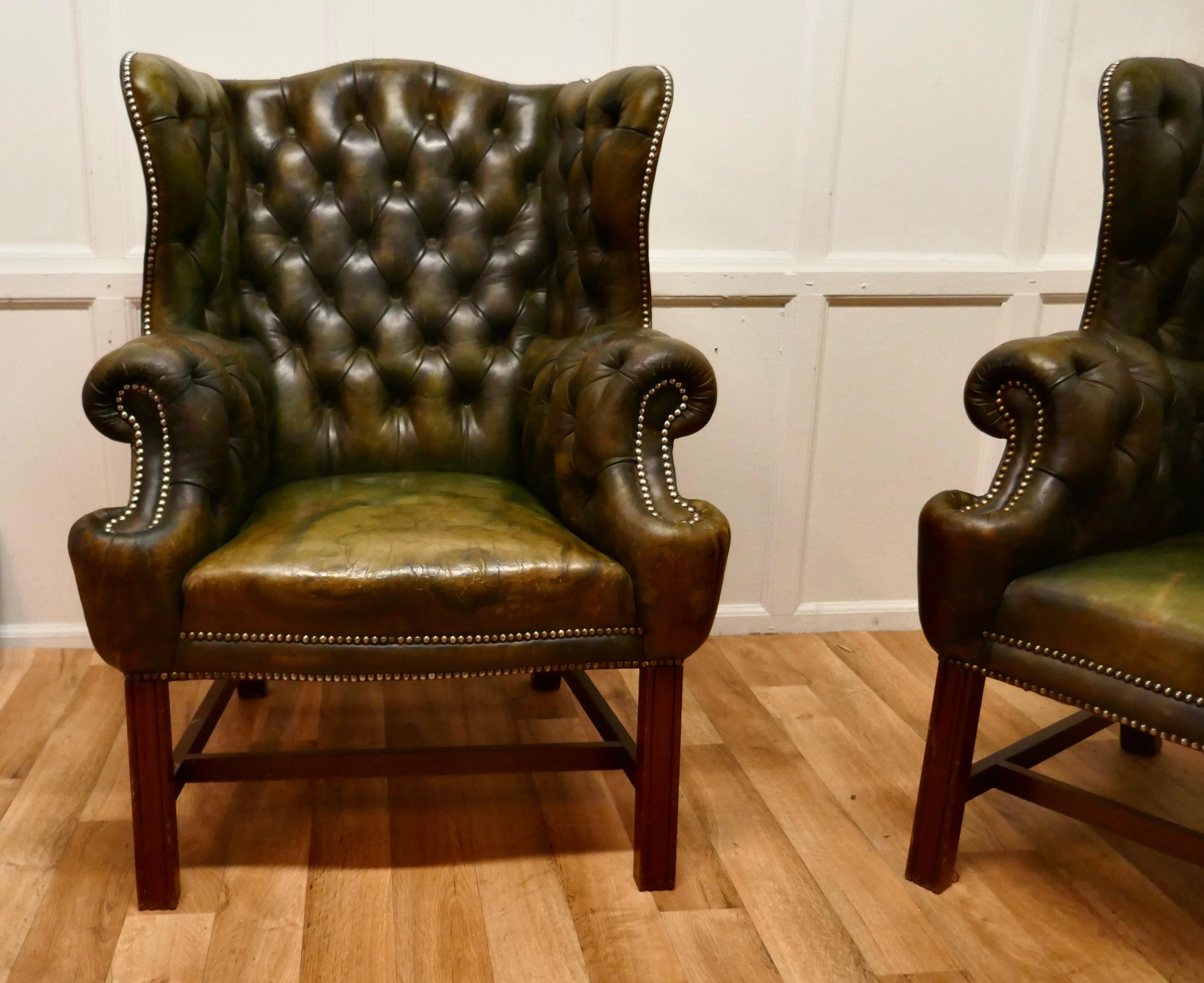 A pair of gentleman’s wing back leather chesterfield library chairs.

These are very roomy chairs, the ultimate in Vintage Country House Chic, the leather upholstery is original with the great character and softness that can only be achieved with
