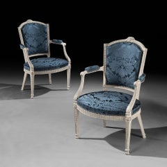 A Pair of George III carved and painted armchairs