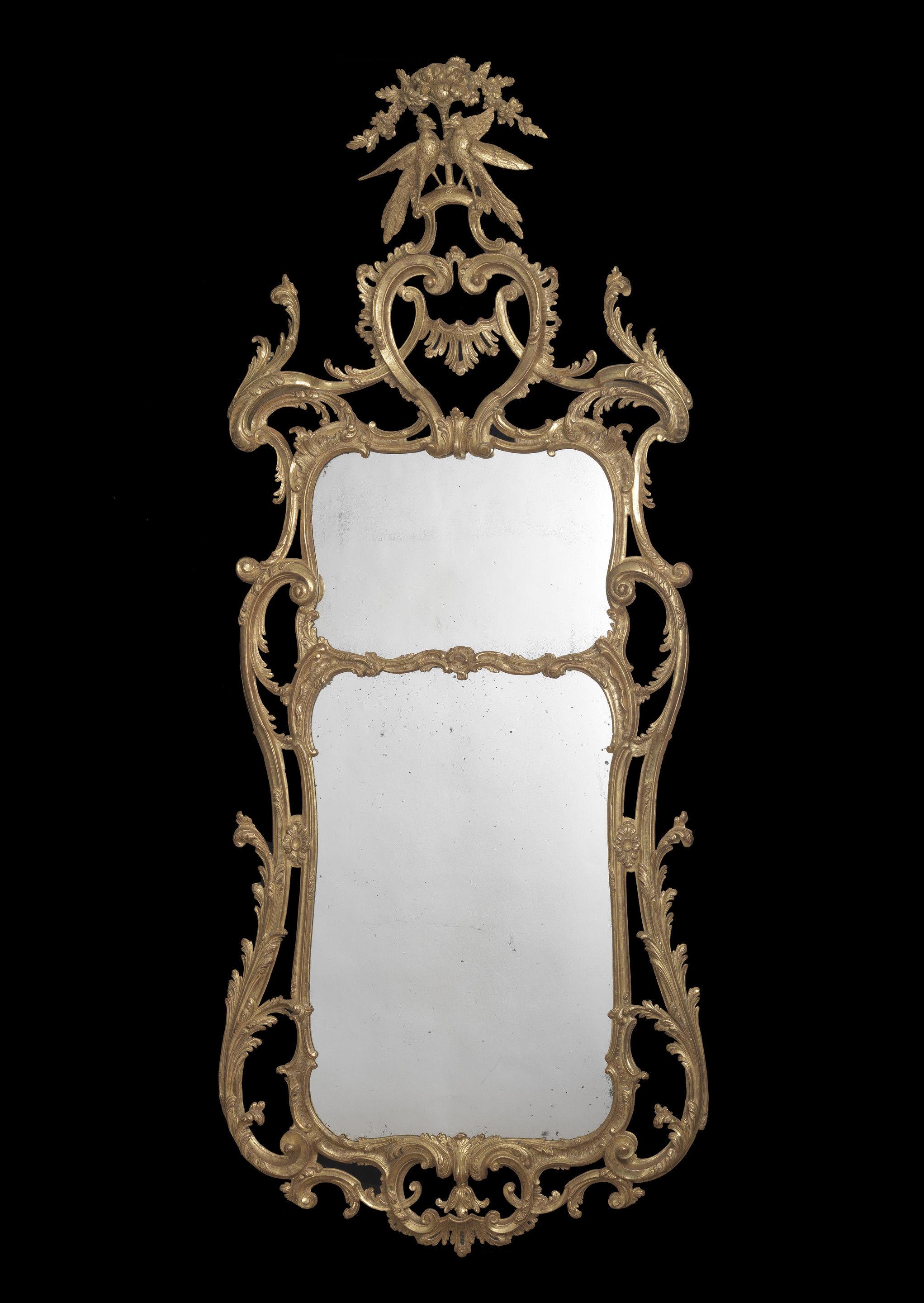 Each with a shaped rectangular divided plate within a scrolling foliate-carved frame, the cresting carved with confronting C-scrolls and rockwork, surmounted by a pair of billing birds and flowerheads.

Provenance:
Almost certainly supplied to