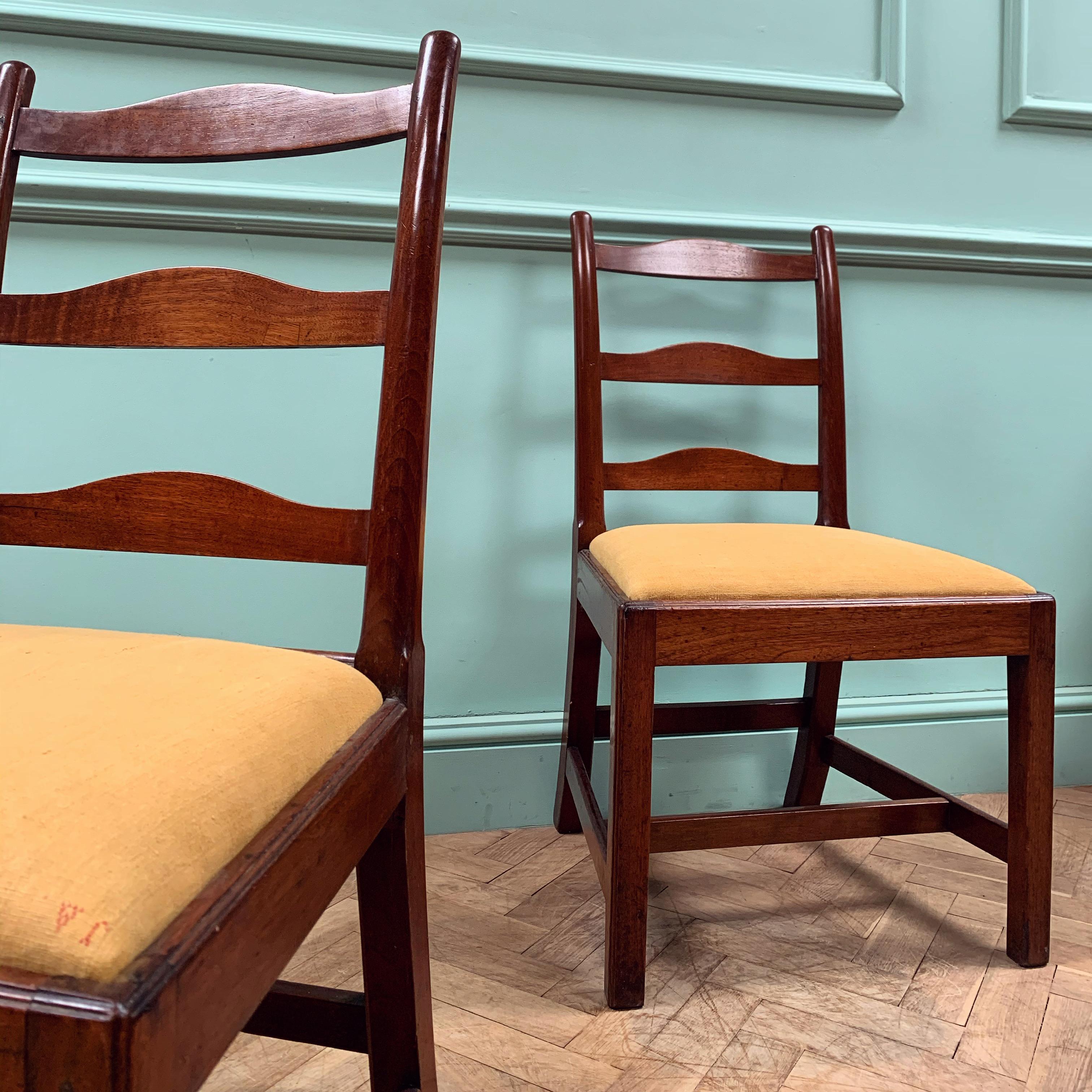 A pair of striking mahogany chairs, with elegant raking leg and ladder back. The seat pads now covered in hand dyed antique linen and ready to use. 

English, George III

H 94.5 x W 54.5 x D52.5 cms

Seat Height 45 cms