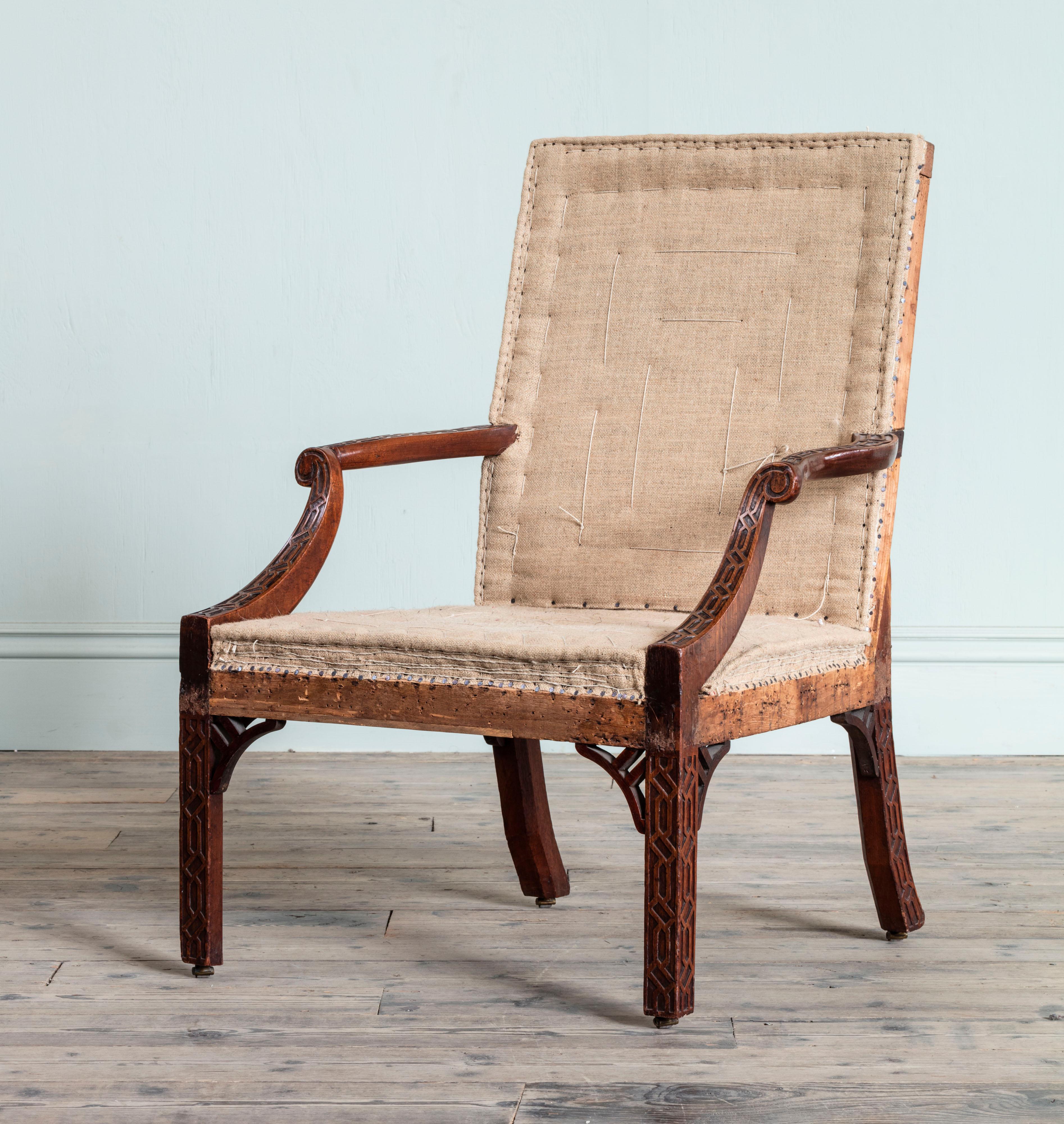 The arms and legs with exceptional blind fretwork carving, on leather casters with stitched hessian upholstery. In the manner of William Masters.

Provenance: The Oxley family, The Hall, Ripon, Yorkshire and by family descent.

Pair of