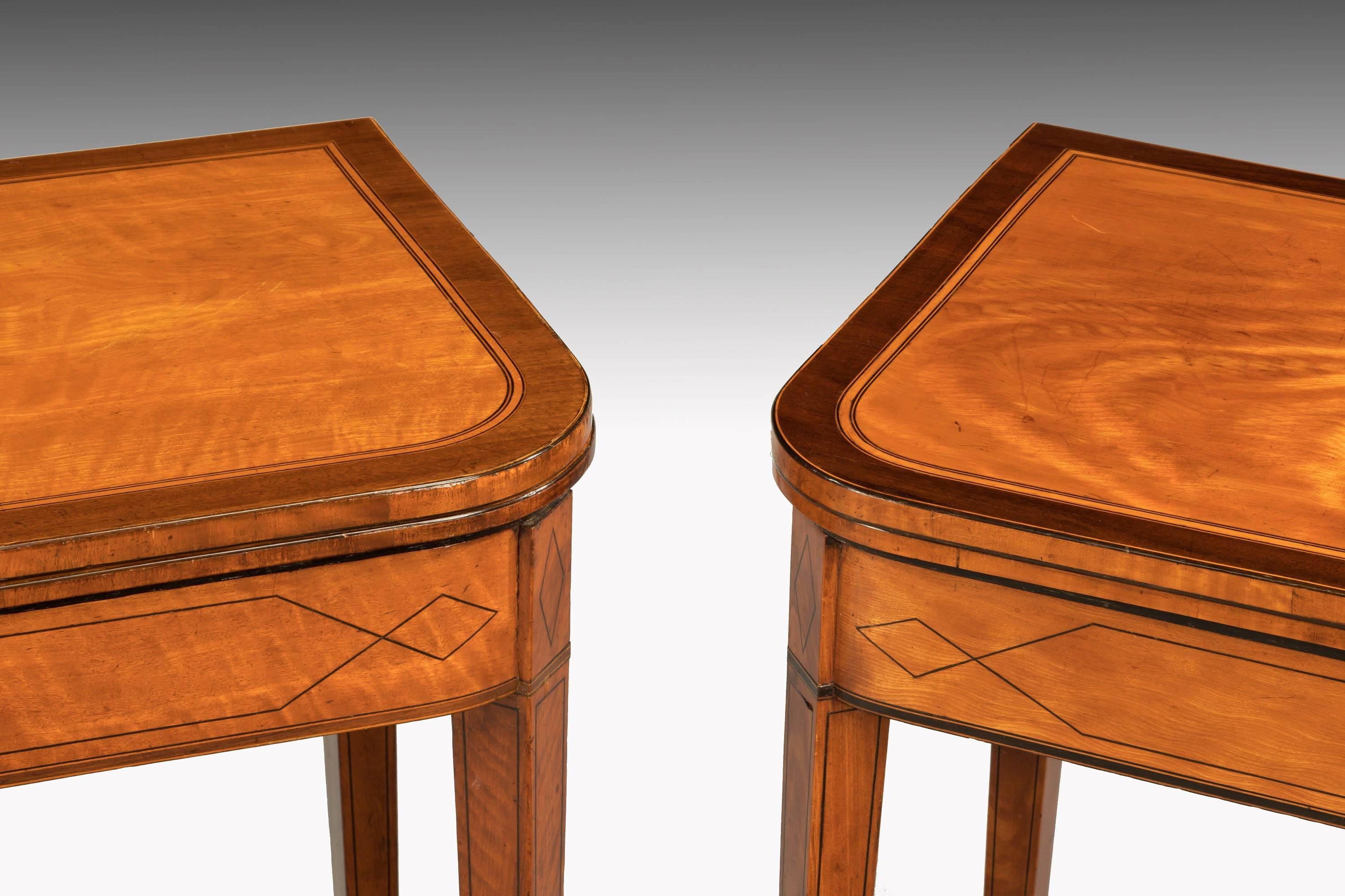 A good pair of George III period satinwood tables. One for cards and one for tea. Fine ebony line inlay, the tops broadly banded with contrasting timbers. Tapering square section supports and line inlay.