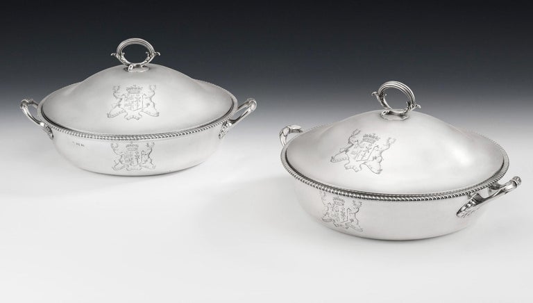 The Taymouth Castle dishes. A very fine and unusual pair of George III Covered Serving Dishes made in London in 1794 by Henry Green.

The Dishes are circular in form with an everted rim decorated with gadrooning. The two side leaf and tie handles