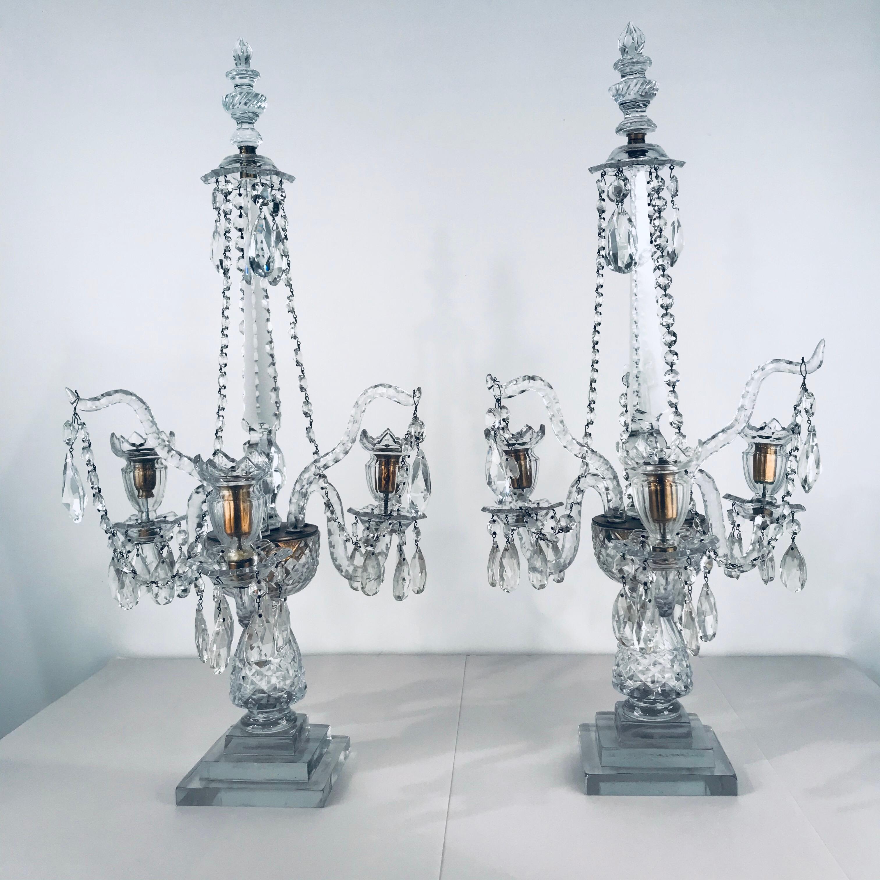 This large and stunning pair add a blaze of reflected light to your dining room. Interspersed among the three candle bearing arms are three shaped branches. The central spire is of tapering triangular section. Cut beaded chains hang down beneath a
