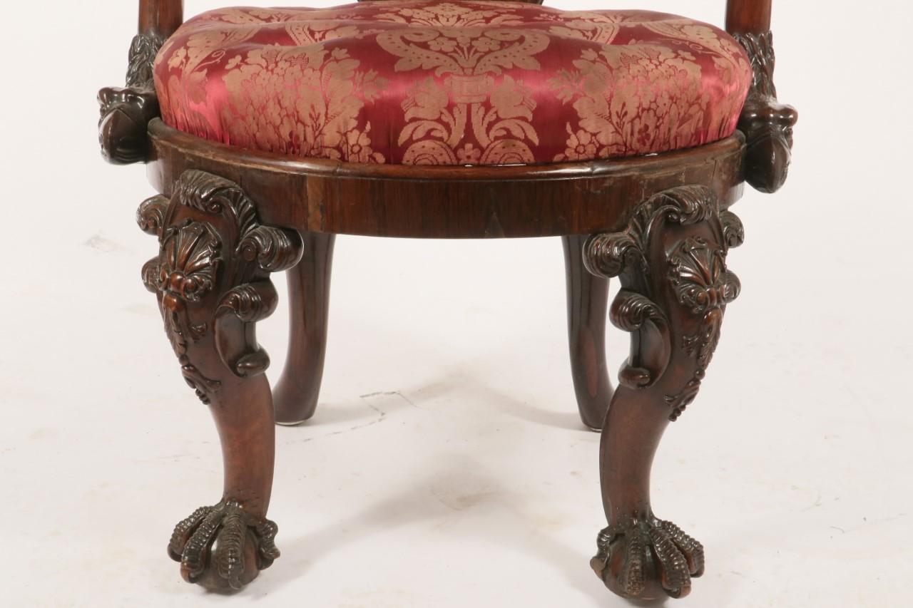 A pair of George IV mahogany library armchair
By Gillows, circa 1825-1830
The shaped back and shepherd's crook arms held by an eagles head above an oval drop-in seat on shell and foliate carved cabriole legs with claw and ball feet, the webbing