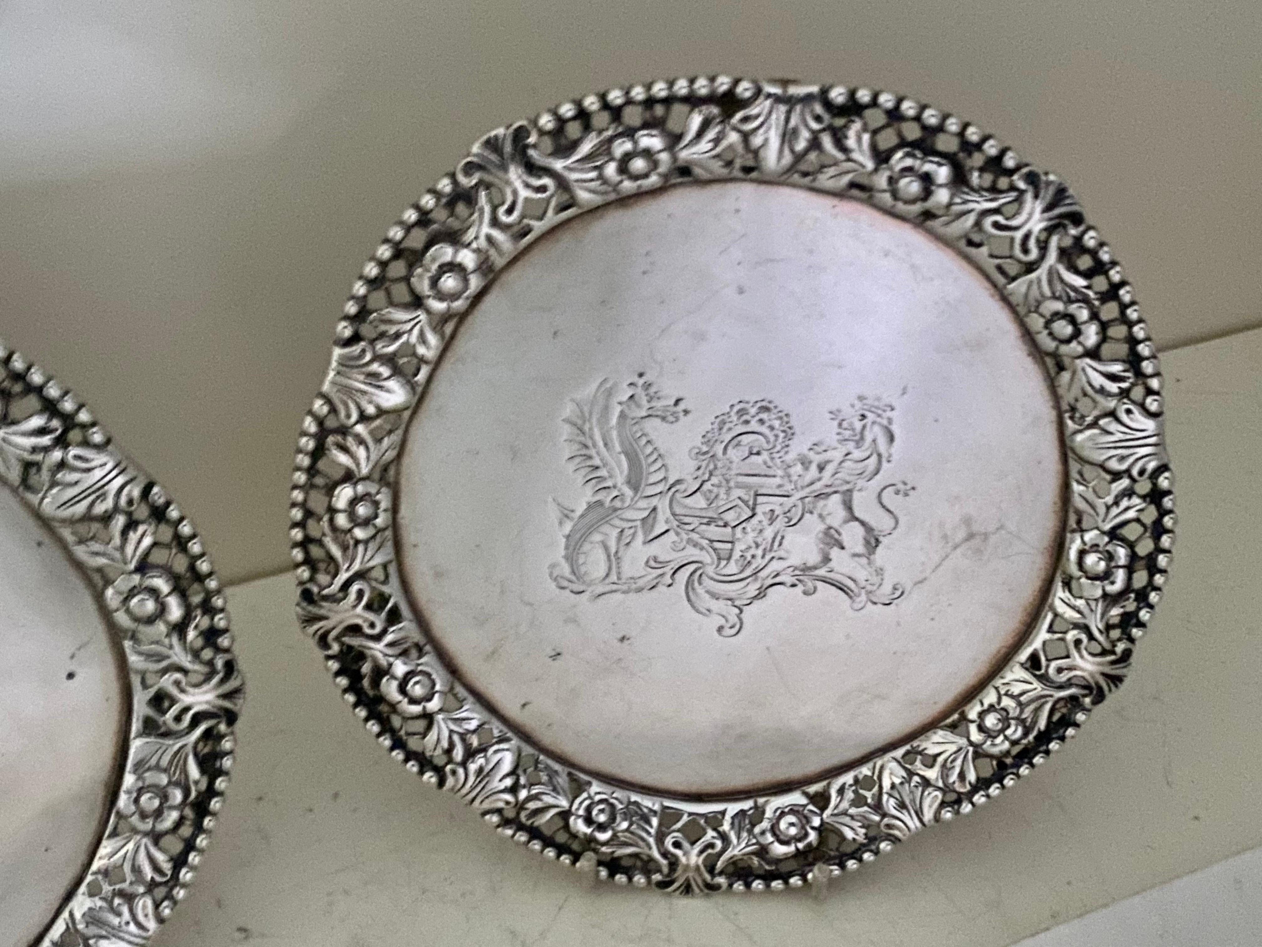 A very fine pair of George IV shaped circular salver, waiters with a cast gallery, Standing on three openwork, foliate feet, the centre engraved bearing the coat-of-arms of Lady Maria Egerton of Alton. within a cast and applied gallery with an