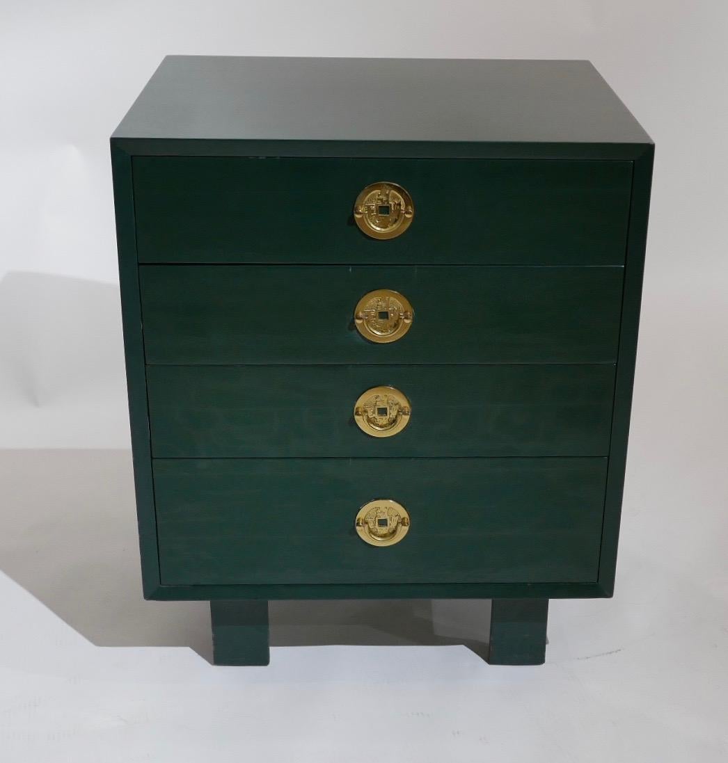 A vintage pair of George Nelson for Herman Miller chests of drawers done in green lacquer with Asian inspired brass pulls. A great mixture of Mid-Century Modern and decorative chinoiserie that would function as smaller four drawer dressers or pier