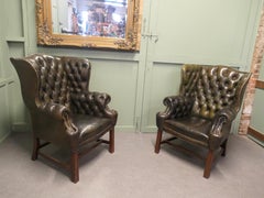 A Pair of Georgian Style Gentleman’s Wing Back Leather Chesterfield Chairs