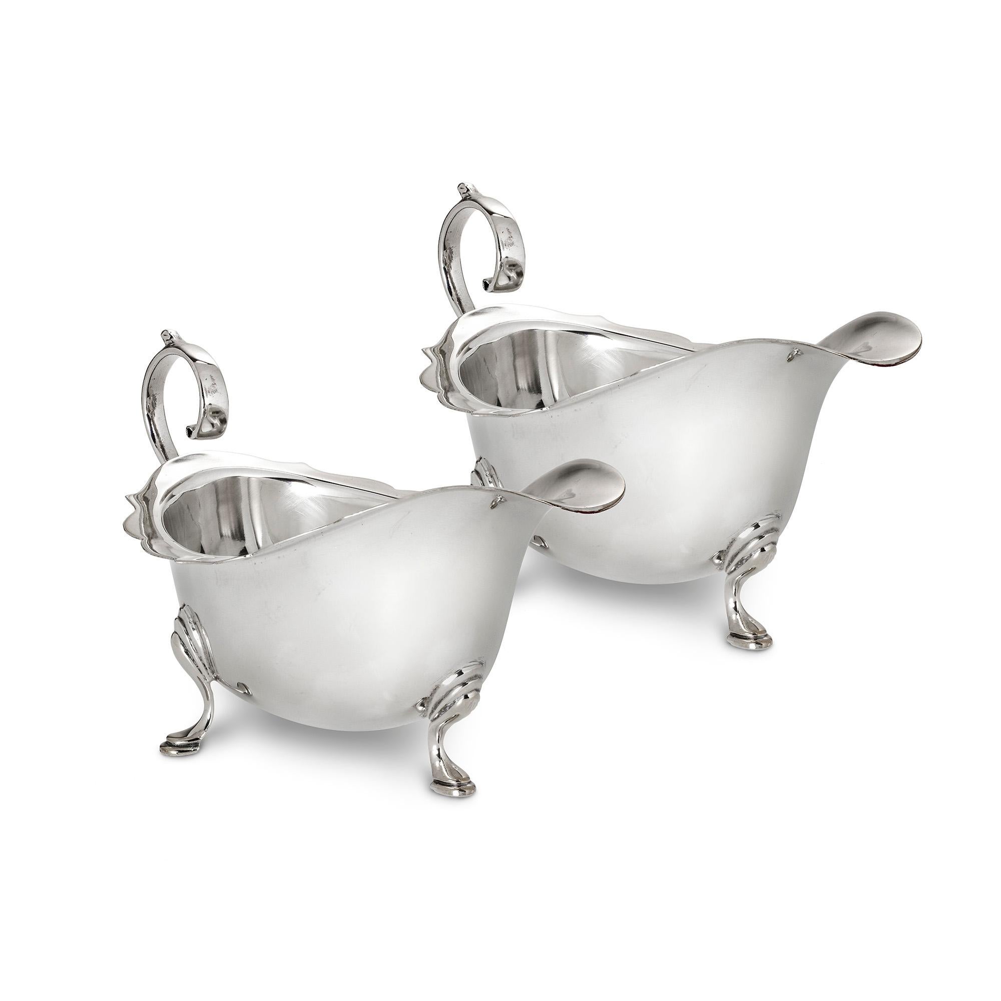 A pair of Georgian style sterling silver sauceboats, with curved edging, upturned scroll handles, on three hoof feet, gross weight 6.5ozs,(203gms), length 5.75