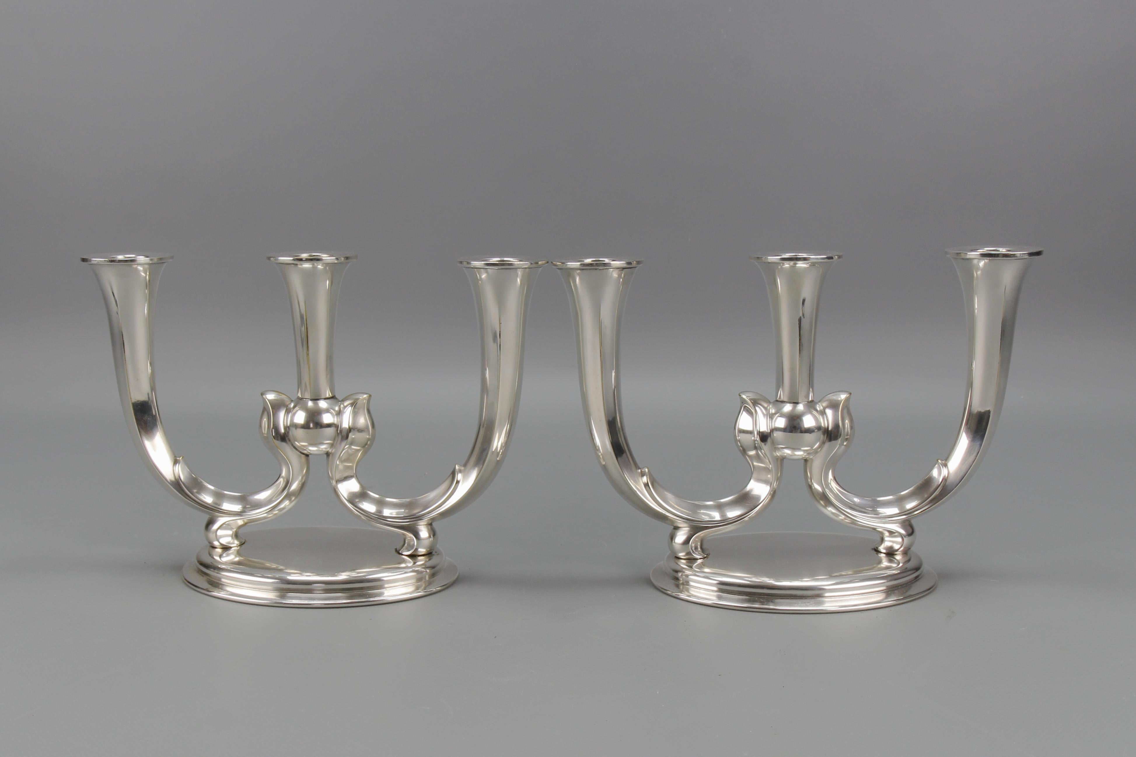 A pair of German WMF Art Deco three-arm candle holders.
An elegant pair of Art Deco nickel-plated brass three-arms candle holders by WMF, Württembergische Metallwarenfabrik, Germany, circa the 1930s.
In good condition with slight signs of