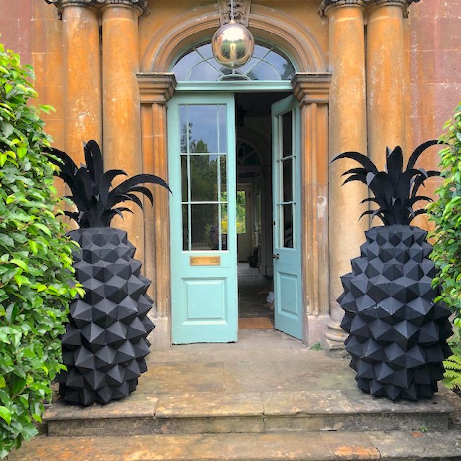 A pair of giant steel pineapple sculptures. Standing at 180cm the pair are an absolutely stunning statement for internet or external use.
 Every facet is individually cut an welded then coated with marine paint to protect the metal from the