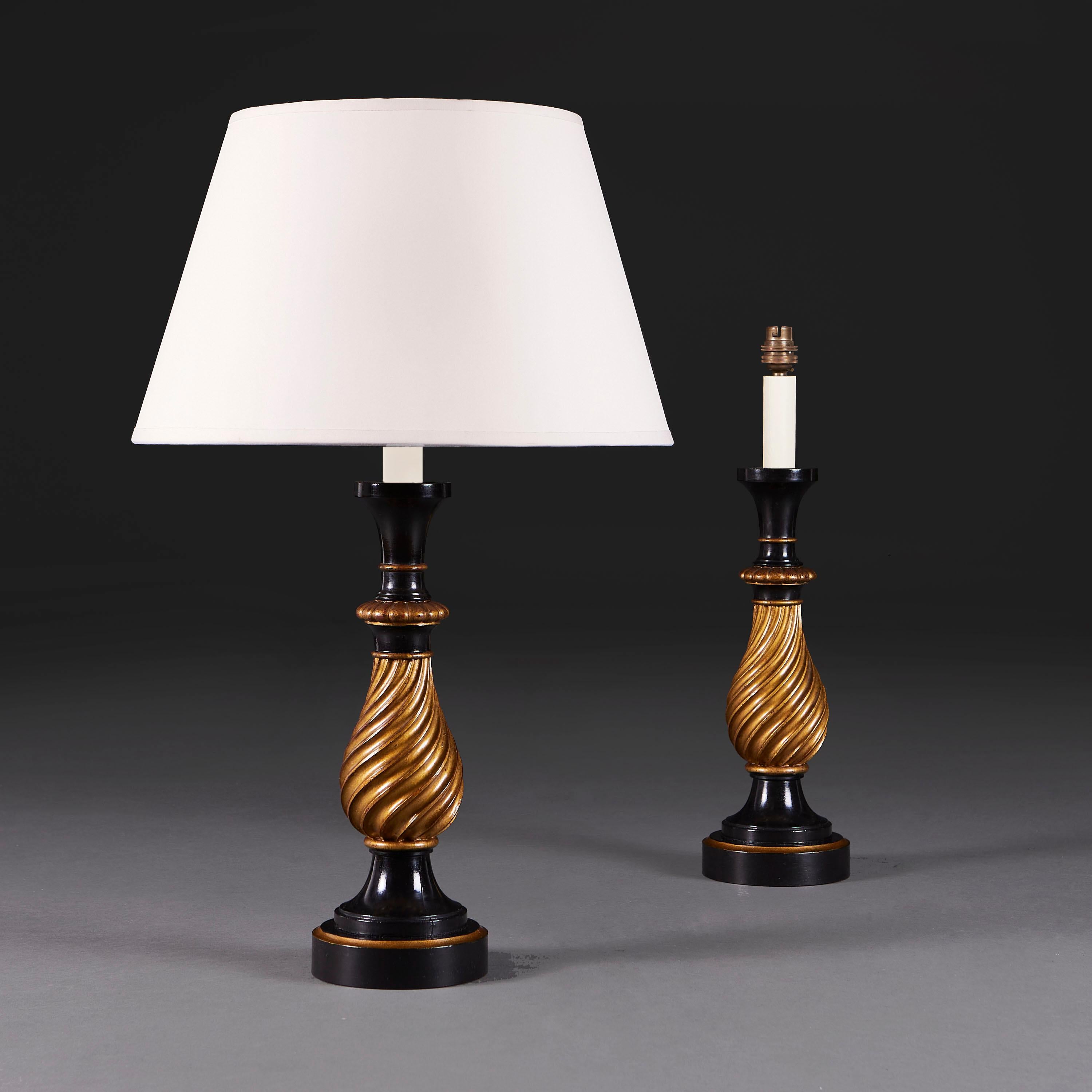 England, circa 1910

A pair of Edwardian spiral turned baluster lamps with gilded and ebonised sections all supported on a circular plinth base, now converted as lamps.

Height 40.50cm
Diameter of base 12.00cm

Please note: This is currently wired