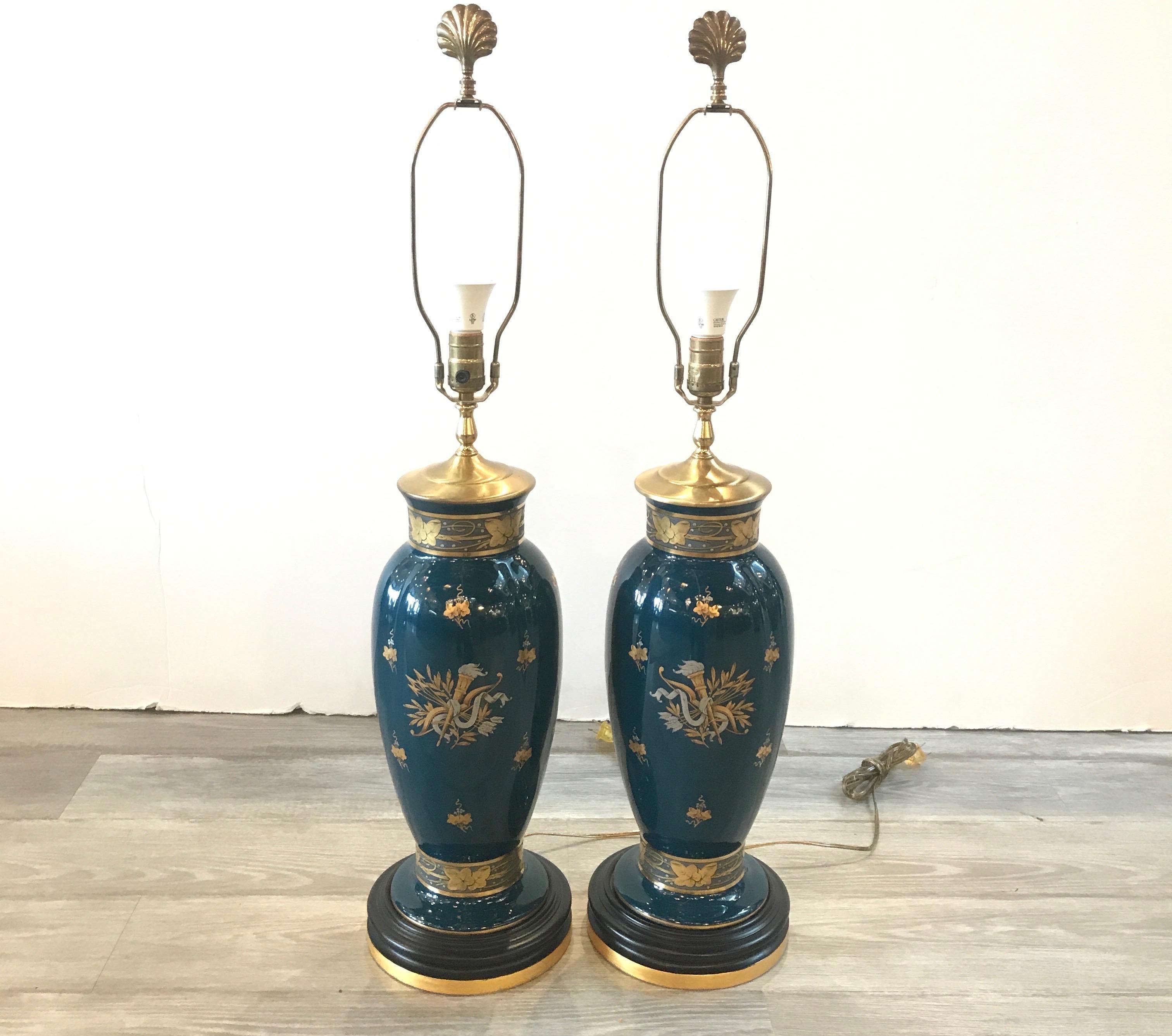 A pair of porcelain lamps in deep teal with silver and gilt decoration the vase form with a black and cold base. The wiring is modern and safe. The shades are for photographic purposes and not included. 33 inches to the top of the shade, 22 inches