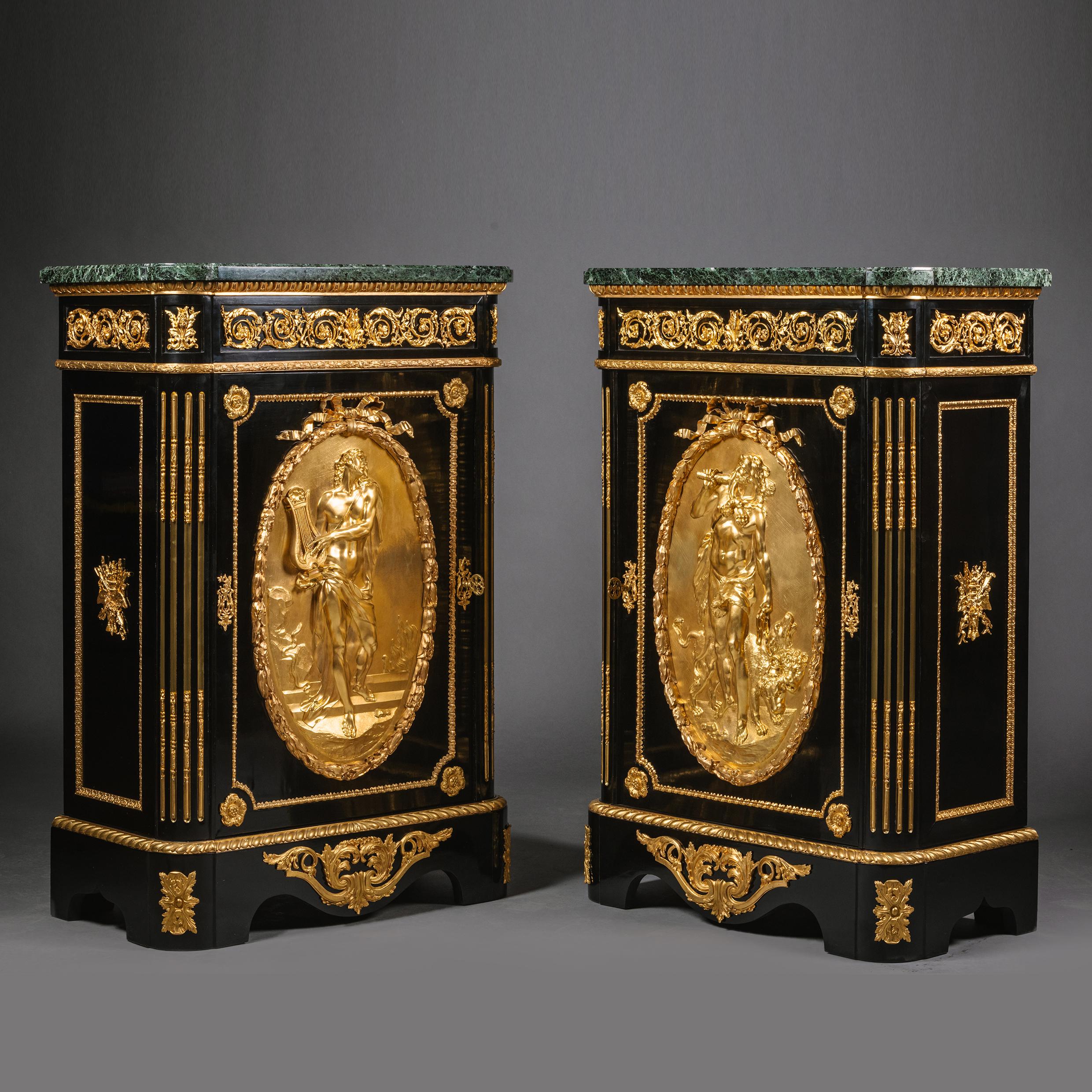 A pair of French gilt-bronze mounted and ebonised meubles d'appui, by Mathieu Béfort dit Béfort Jeune. 

Each has a vert maurin marble top above a cupboard door applied with large oval gilt-bronze medallions depicting Hercules and Orpheus, opening