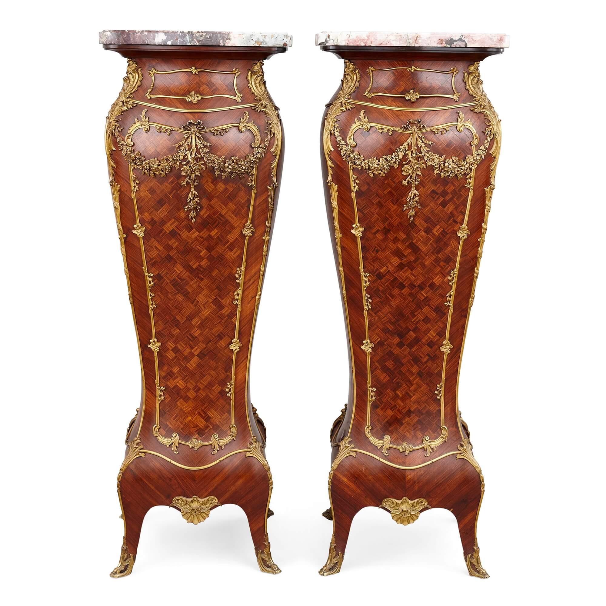 A pair of gilt-bronze, parquetry and marble pedestal by Alexandre Hugnet, Paris
French, Late 19th century
Measures: Height 122cm, width 43cm, depth 43cm

Made by the Parisian craftsman Alexandre Hugnet, son of the cabinet maker Ainé Hugnet, whom