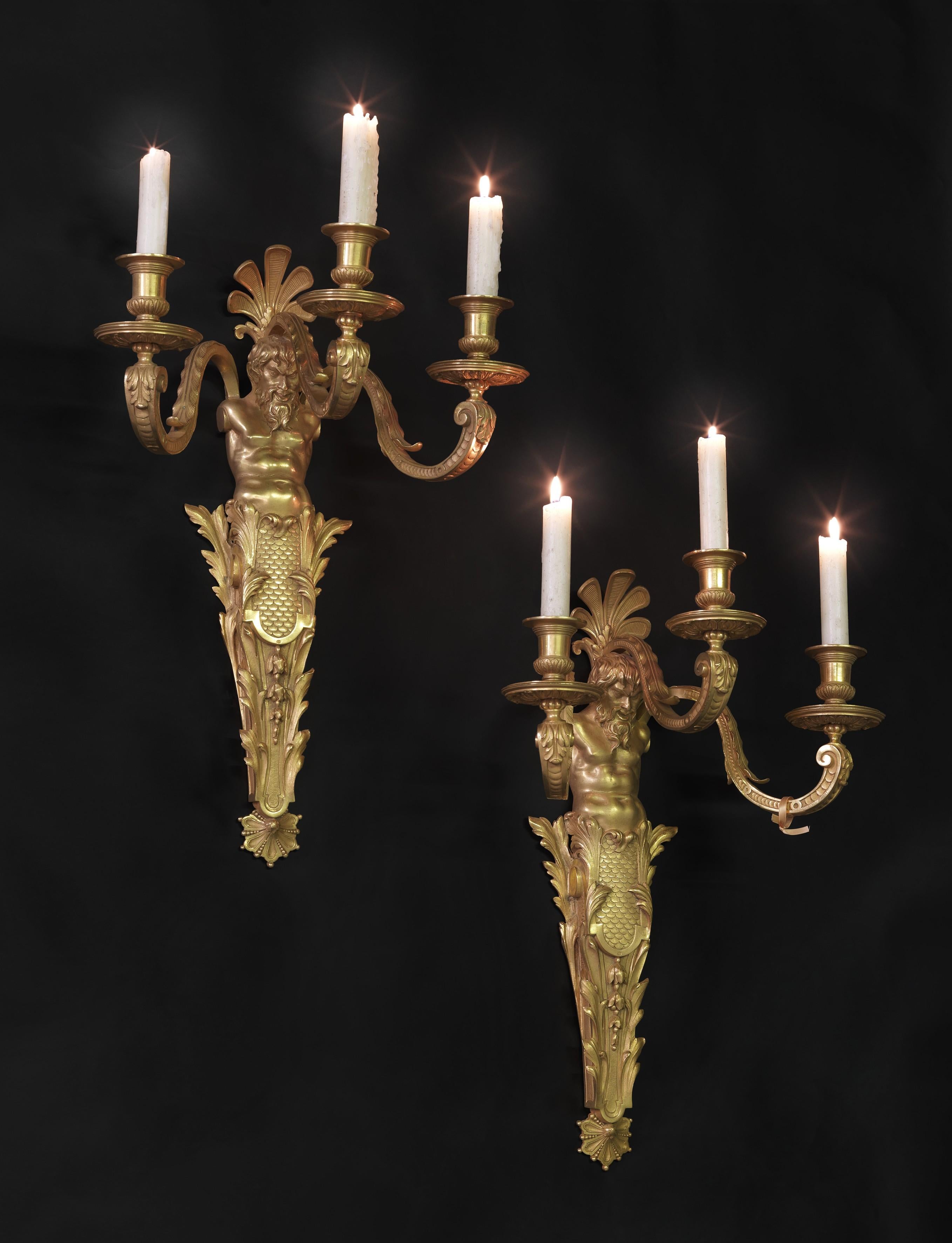A Fine Pair of Gilt-Bronze Three-Light Wall-Appliques by Henry Dasson.

French, Circa 1880. 

Stamped to the bronze 'HD' in an oval medallion.

This fine pair of gilt-bronze appliqués each have a central herm figure issuing three candle branches