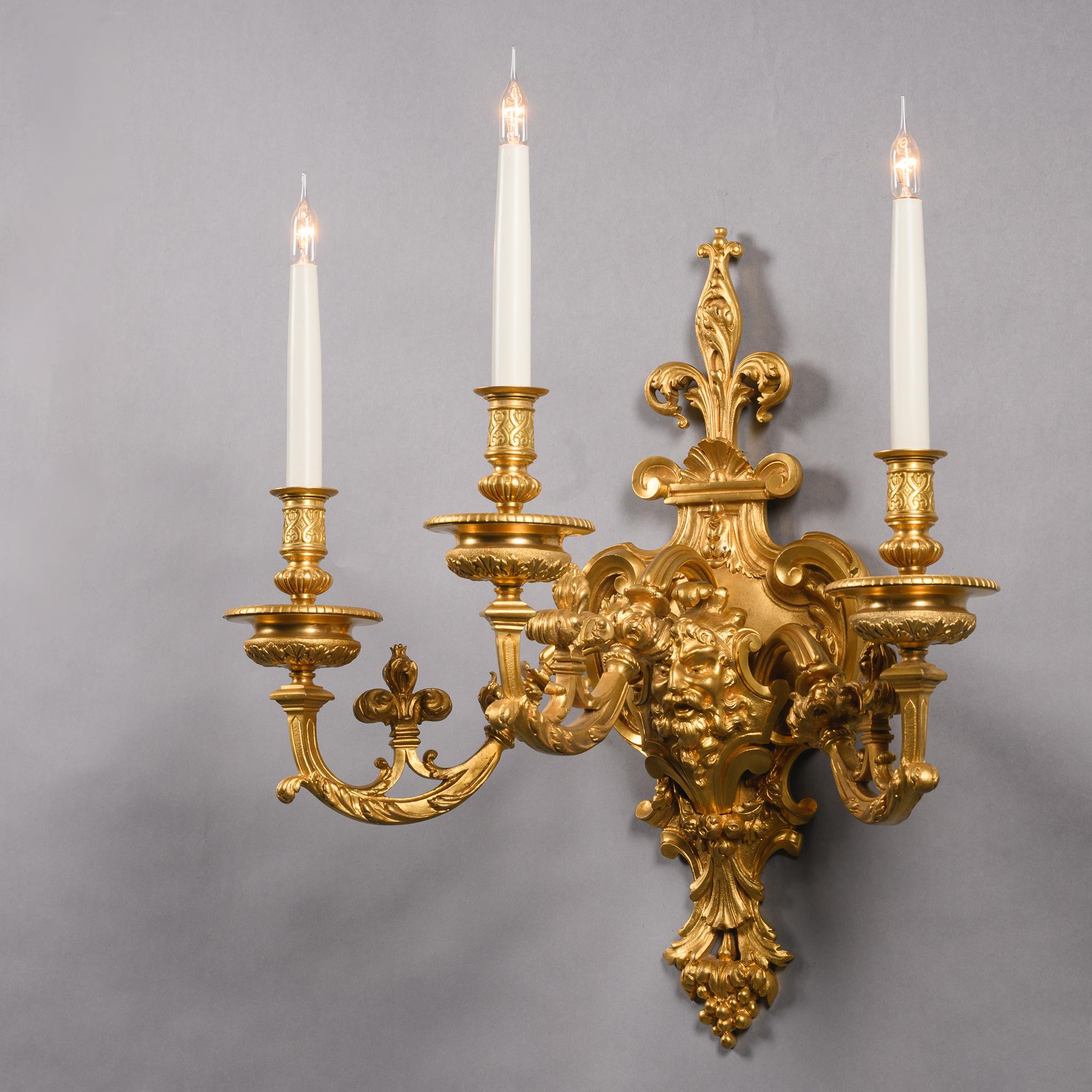 Français Paire d'appliques murales à trois lumières en bronze doré en vente