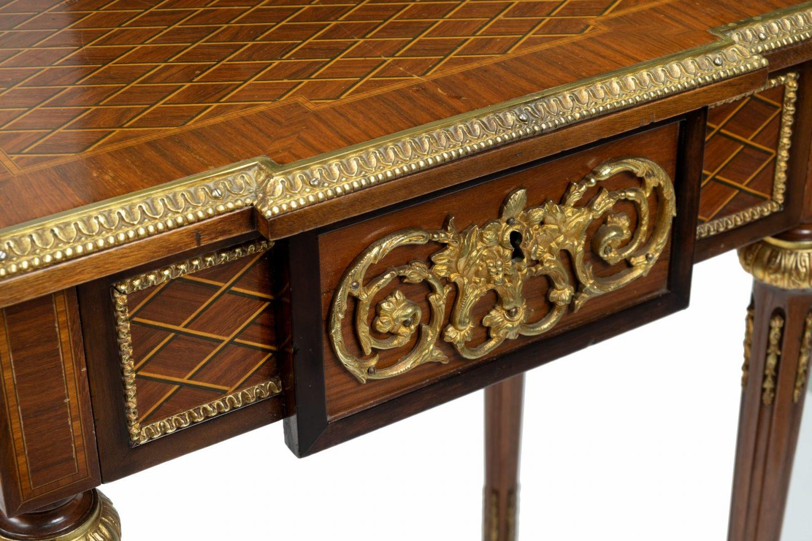 A pair of French kingwood, parquetry and gilt brass-mounted rectangular end tables of Louis XVI design, the parquetry top inlaid with boxwood and ebonized stringings and rosewood bandings, bellflower and bead pattern mounts, fitted one frieze drawer