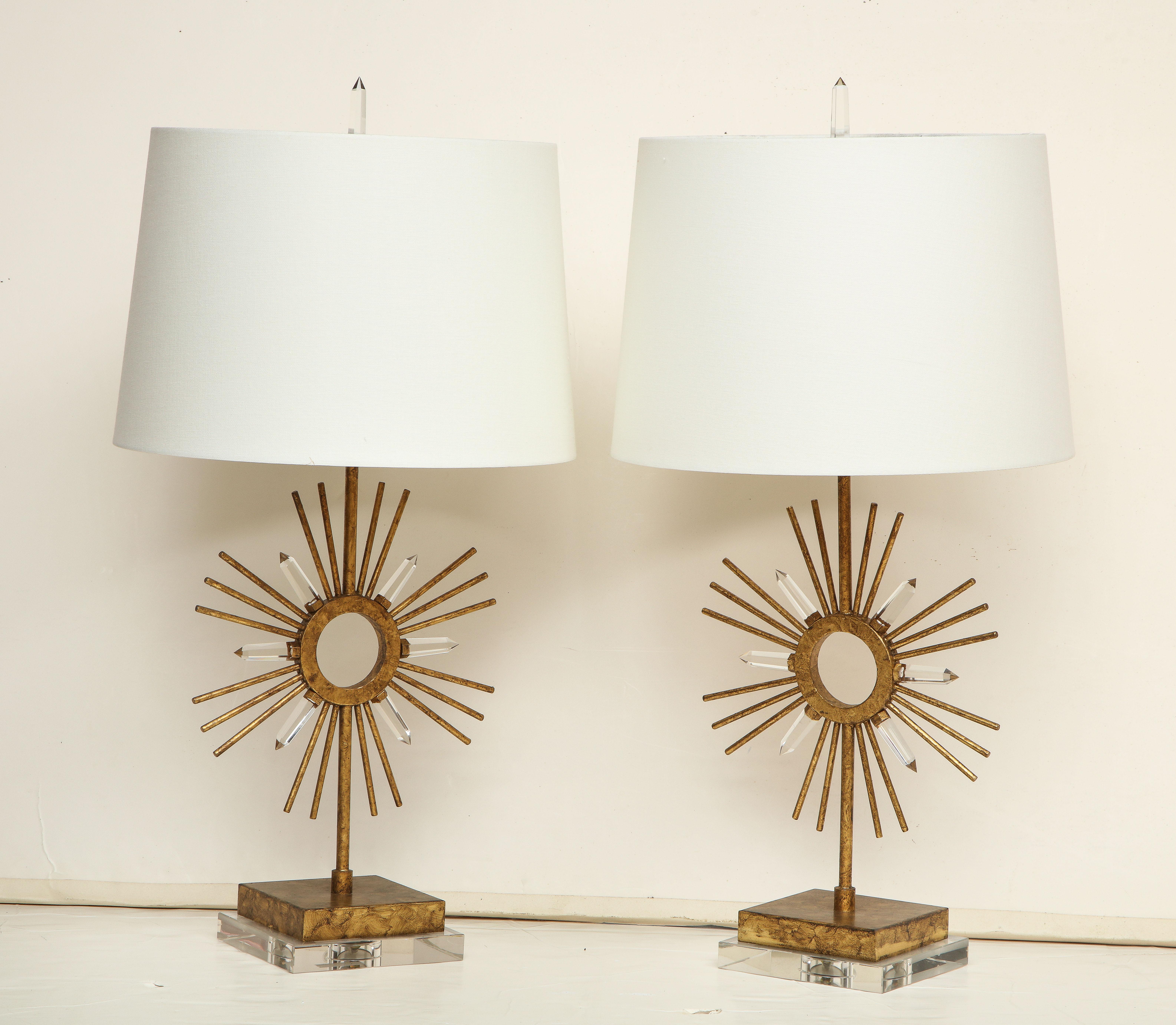 A pair of striking gilt metal lamps with a sunburst decoration on a Lucite base. Priced at $850 per lamps.