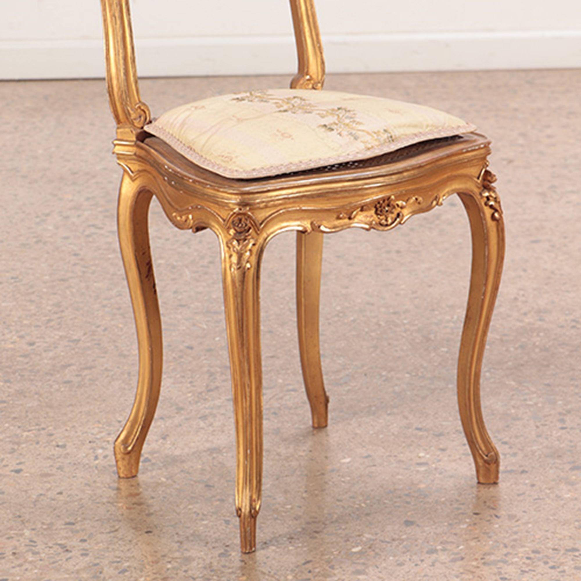 A pair of giltwood and carved French Louis XV style side chairs with original gilt finish, circa 1900.