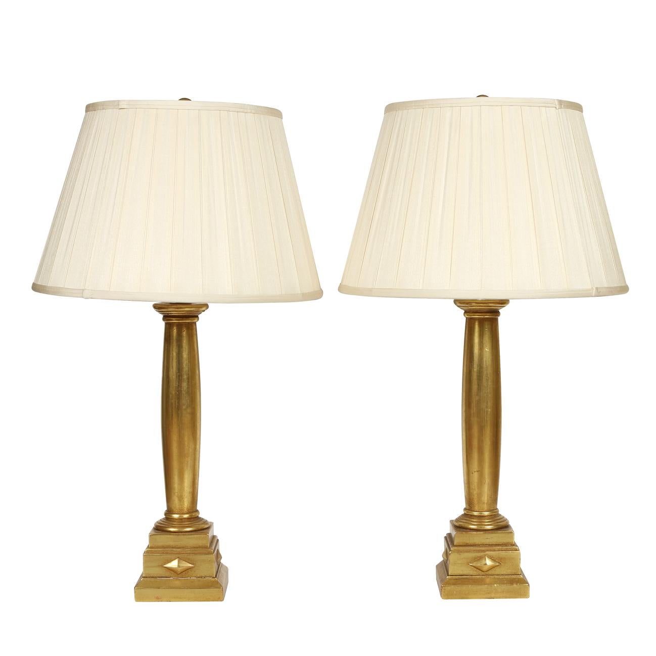 A stately pair of giltwood column-form lamps.