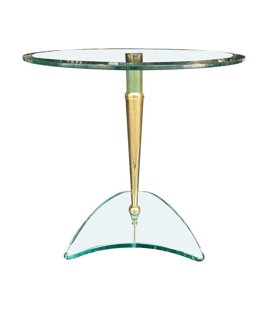 A pair of glass and brass circular side tables in the style of Fontana Arte with brass legs with faux green leather detailing mounted on a triangular glass base. Very good quality pieces with interesting design.