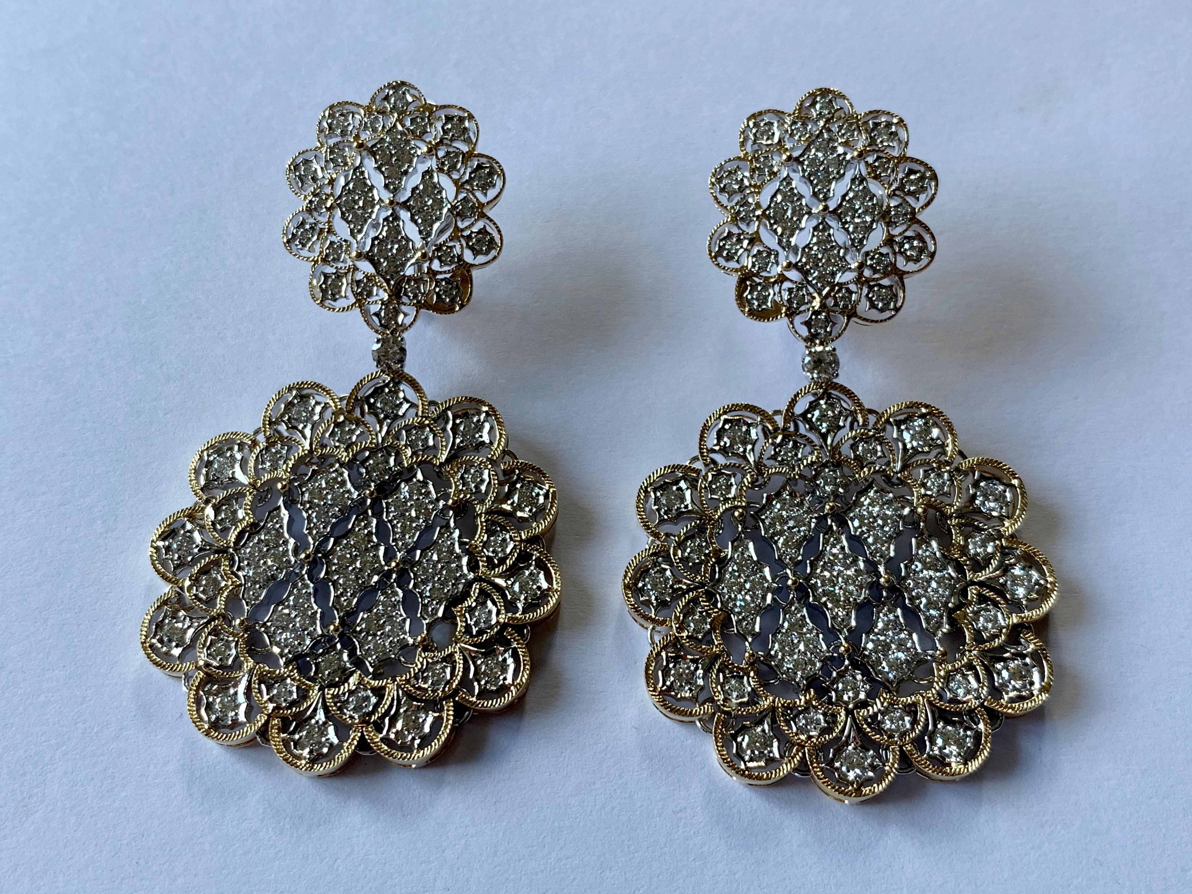 A pair of 18 K yellow and white Gold openwork drop earrings reminiscent of the italian designer Bucellati. Set with 182 brilliant cut Diamonds weighing 4.23 ct, G color, vs clarity. 
Masterfully handcrafted piece! Authenticity and money back is