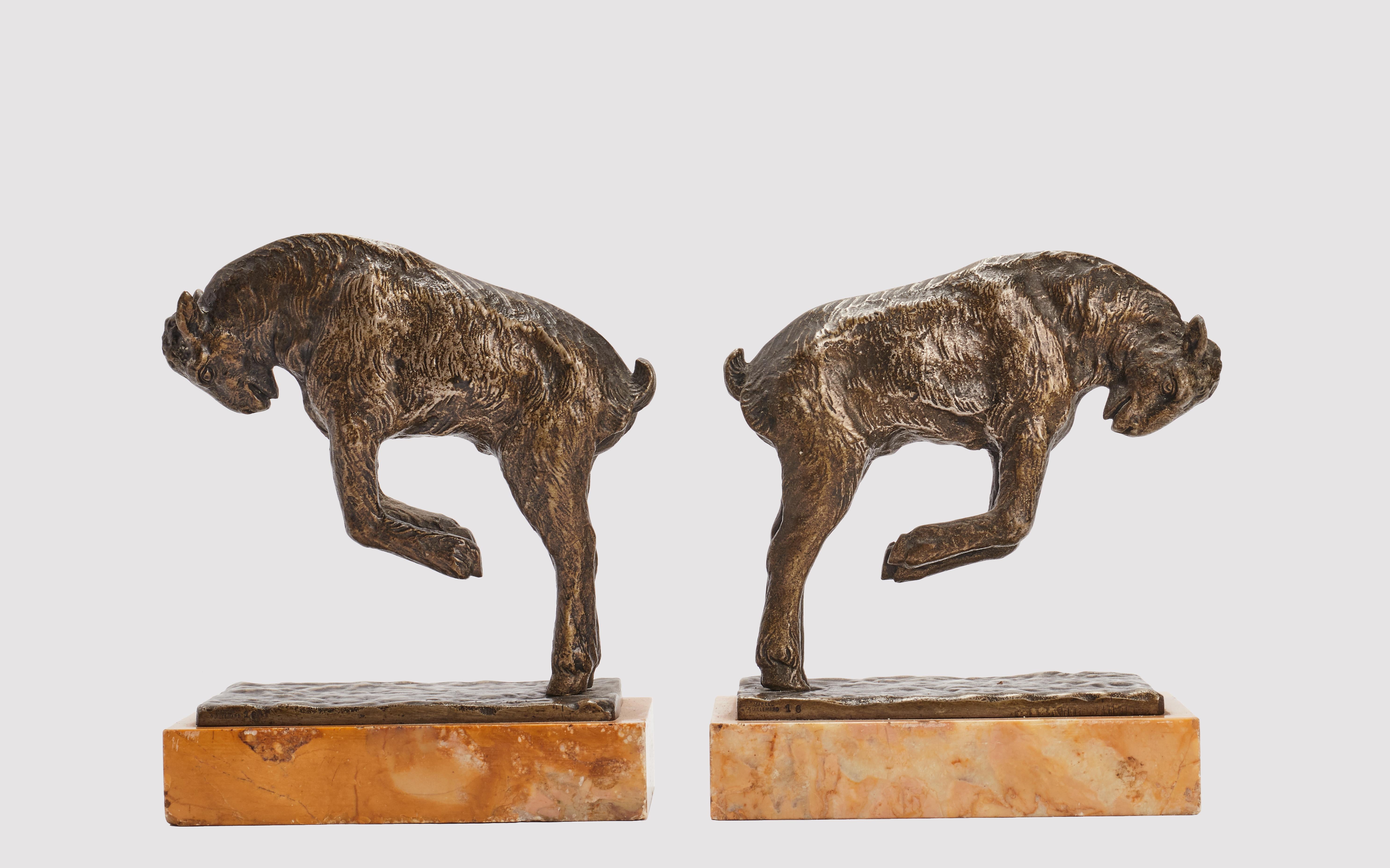 Pair of bookends in bronze, yellow Siena marble base,  representing jumping goats. Signed Pierre Laurel. France circa 1900.