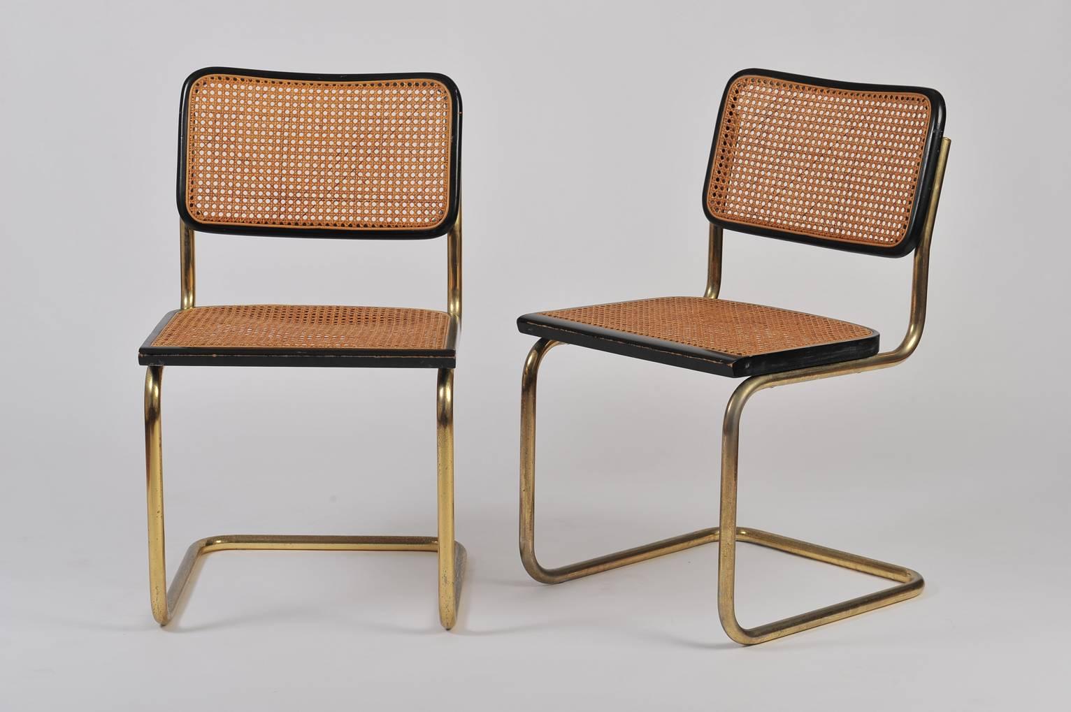 A pair of cane, gold lacquered metal and ebonised beech cantilever chairs
Designed by Hungarian-American designer Marcel Breuer in 1928, model Cesca.

Whilst this iconic piece from the Bauhaus movement is very well know in chrome, our gold
