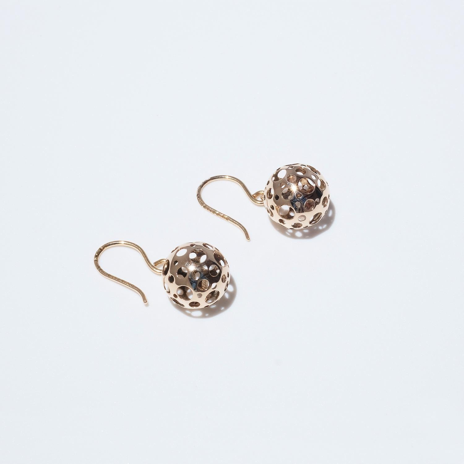 These 14 karat gold earrings are part of Liisa Vitali's famous serie “Leppäkerttu”, which means ladybug. The earrings are shaped as globes with Vitali's signature pattern of circular cut-outs.

The earrings are smallish, but yet eye-catching. This