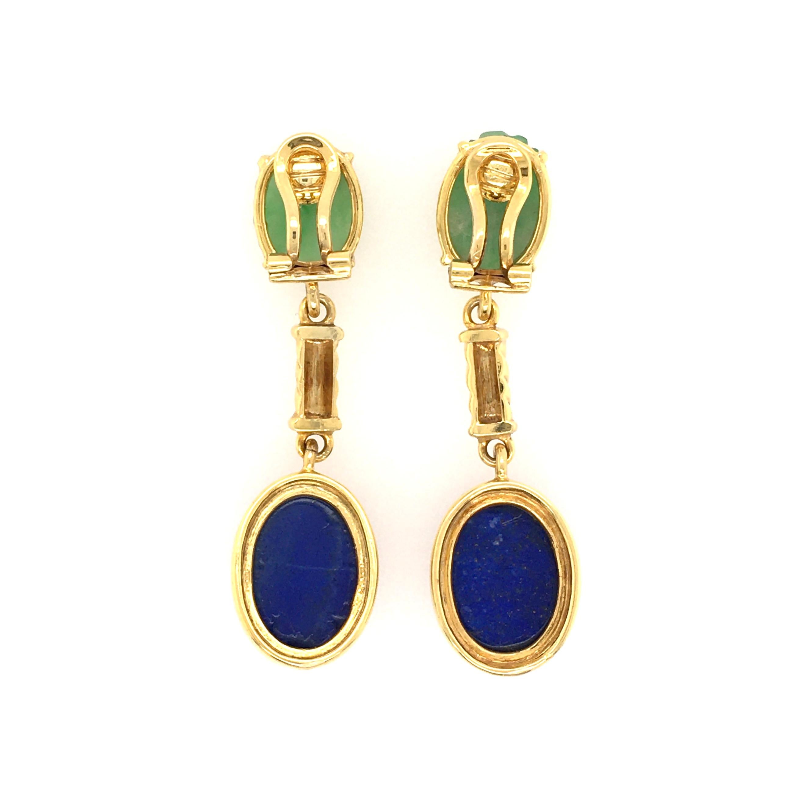 A pair of 14 karat yellow gold, jade and lapis lazuli earrings. Circa 1970. Each suspending an oval cabochon lapis lazuli, measuring approximately 16.0 x 13.0mm, from a ropework link and carved oval jade surmount, measuring approximately 13.5 x