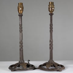 A pair of good quality of hand wrought and twisted iron table lamps