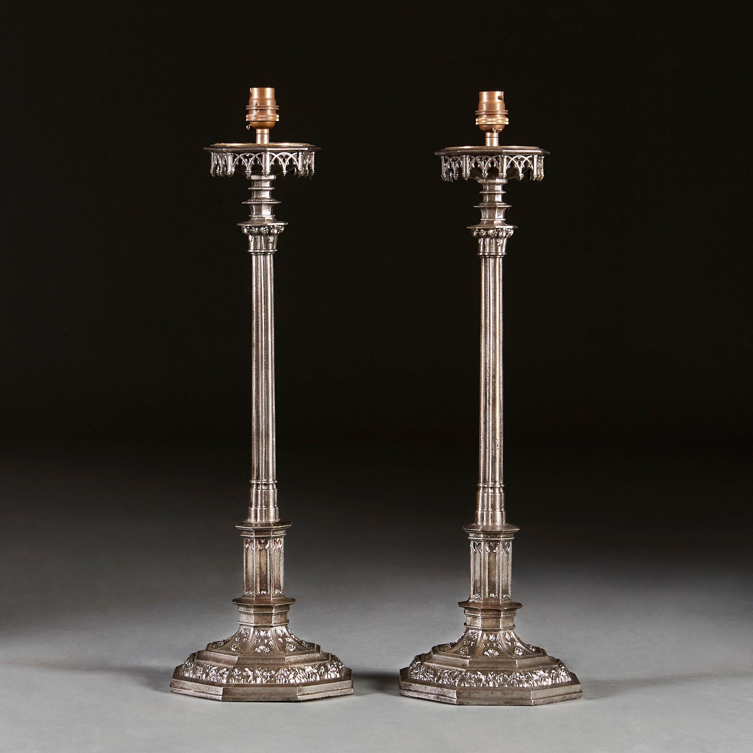 A pair of nineteenth century polished steel candlestick lamps in the Gothic taste, with finely cast octagonal bases, after Augustus Welby Northmore Pugin.

Please note that the lamps are currently wired for the UK, and that the lampshade is not