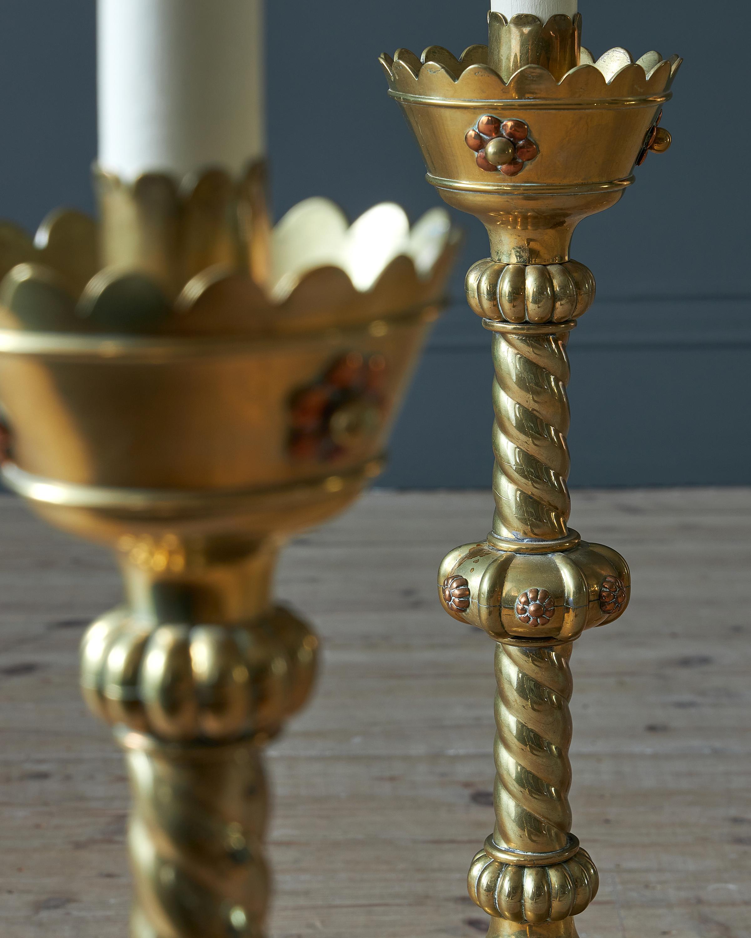 European A pair of brass and copper Gothic Revival candlestick lamp bases, 19th century For Sale