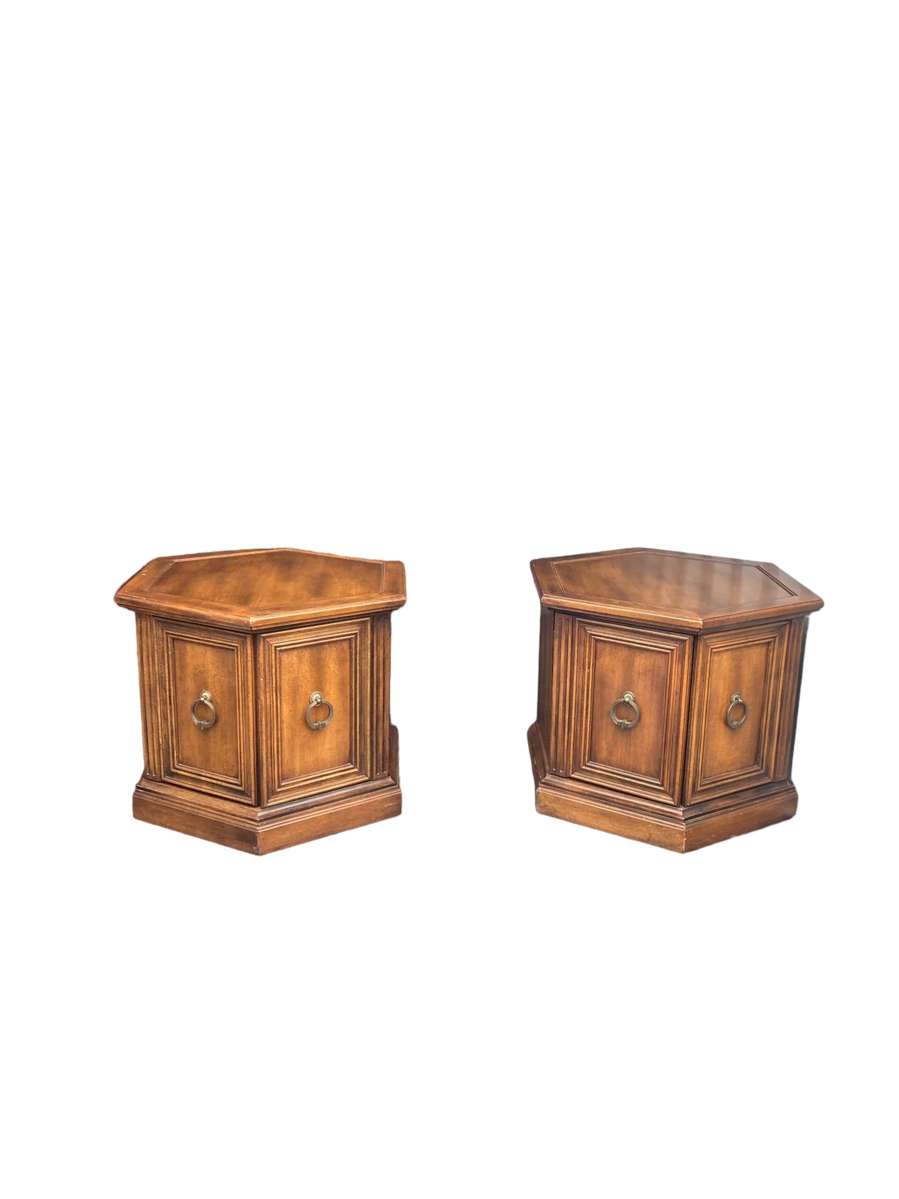 A Pair of Gothic Style Oak Wood Hexagonal Side Tables. Crafted with precision and attention to detail, these tables are the perfect addition to any living space. The sturdy wooden oak ensures durability, while the doors provide ample storage for