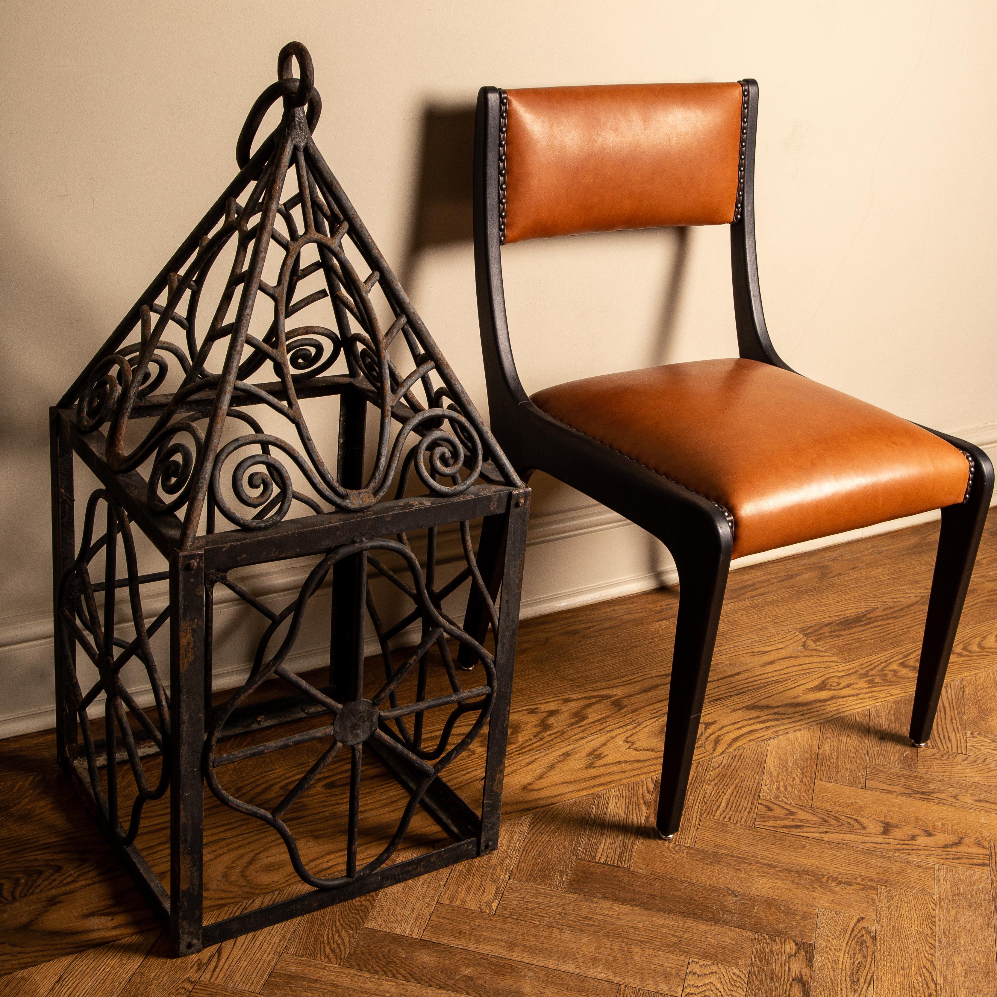 Unusual and elegant pair of heavy hurricane lanterns from France first quarter 20th century. Beautifully fashioned out of solid wrought iron, with unusual ornamental scrolling design. Impressive proportions and superb craftsmanship, featuring
