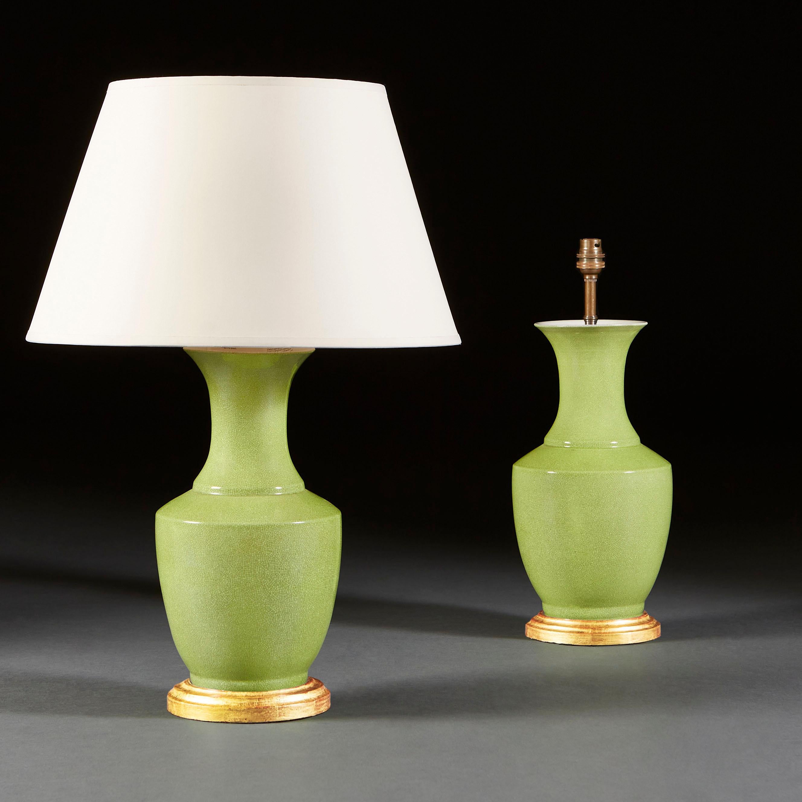 A pair of green ceramic vases as lamps, with flared neck, with gilded bases.

Currently wired for the UK.

Please note: Lampshades not included.
