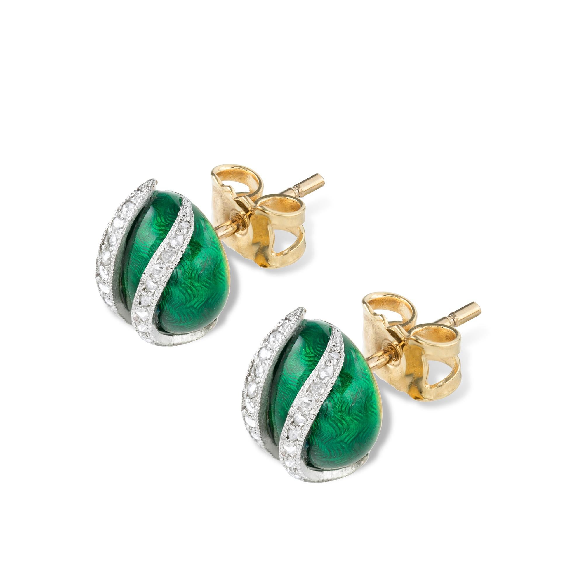 A pair of early twentieth century green enamel and diamond stud earrings, the two rose-cut diamond fine millegrain-set platinum stripes, to a translucent green guilloché enamel ground, all in yellow gold mount with later post and scroll fittings,
