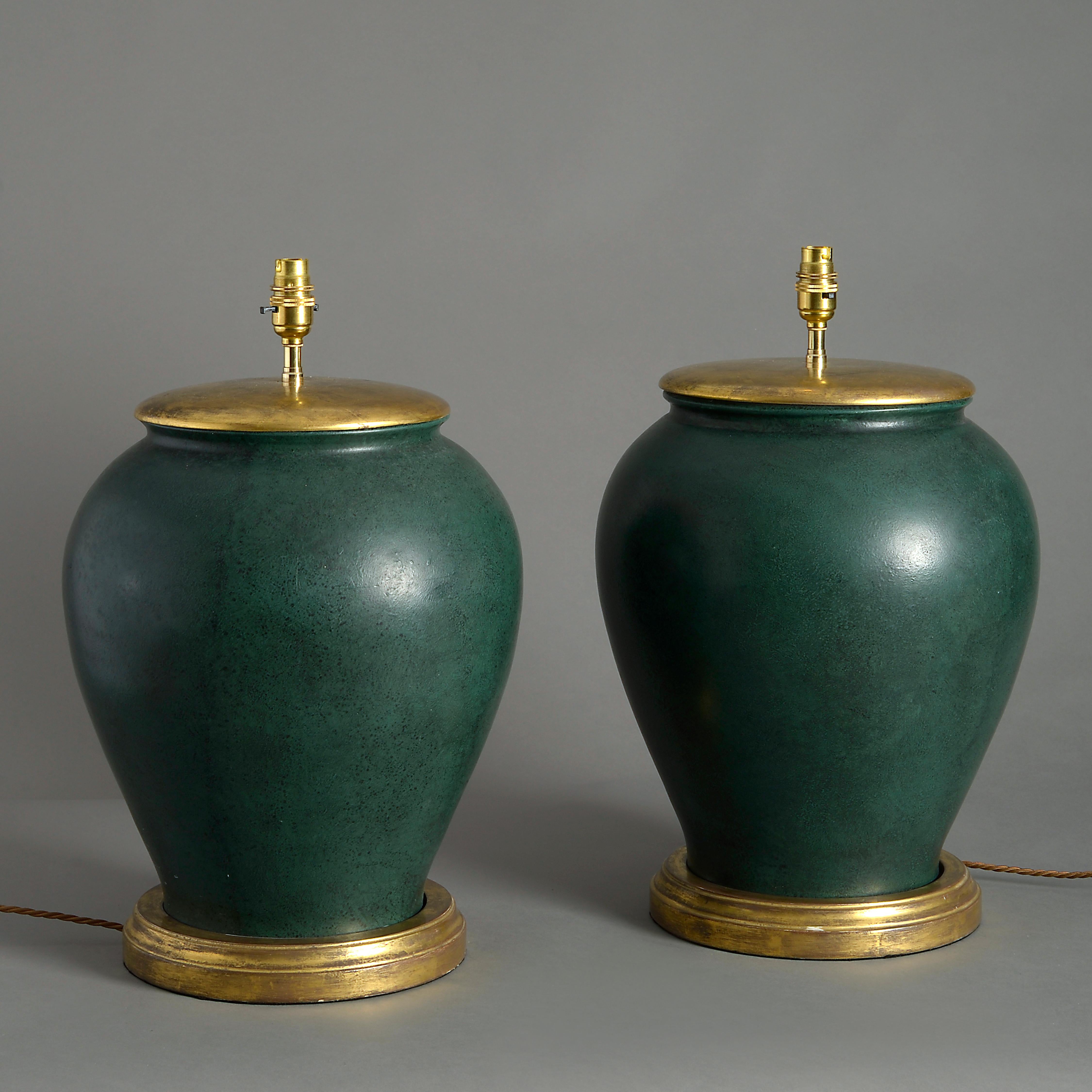 A pair of mid-20th century green cold painted jars of good scale and generous form, now mounted as table lamps, having turned water gilded caps and bases.

Dimensions refer to lamp base and exclude electrical components.

 