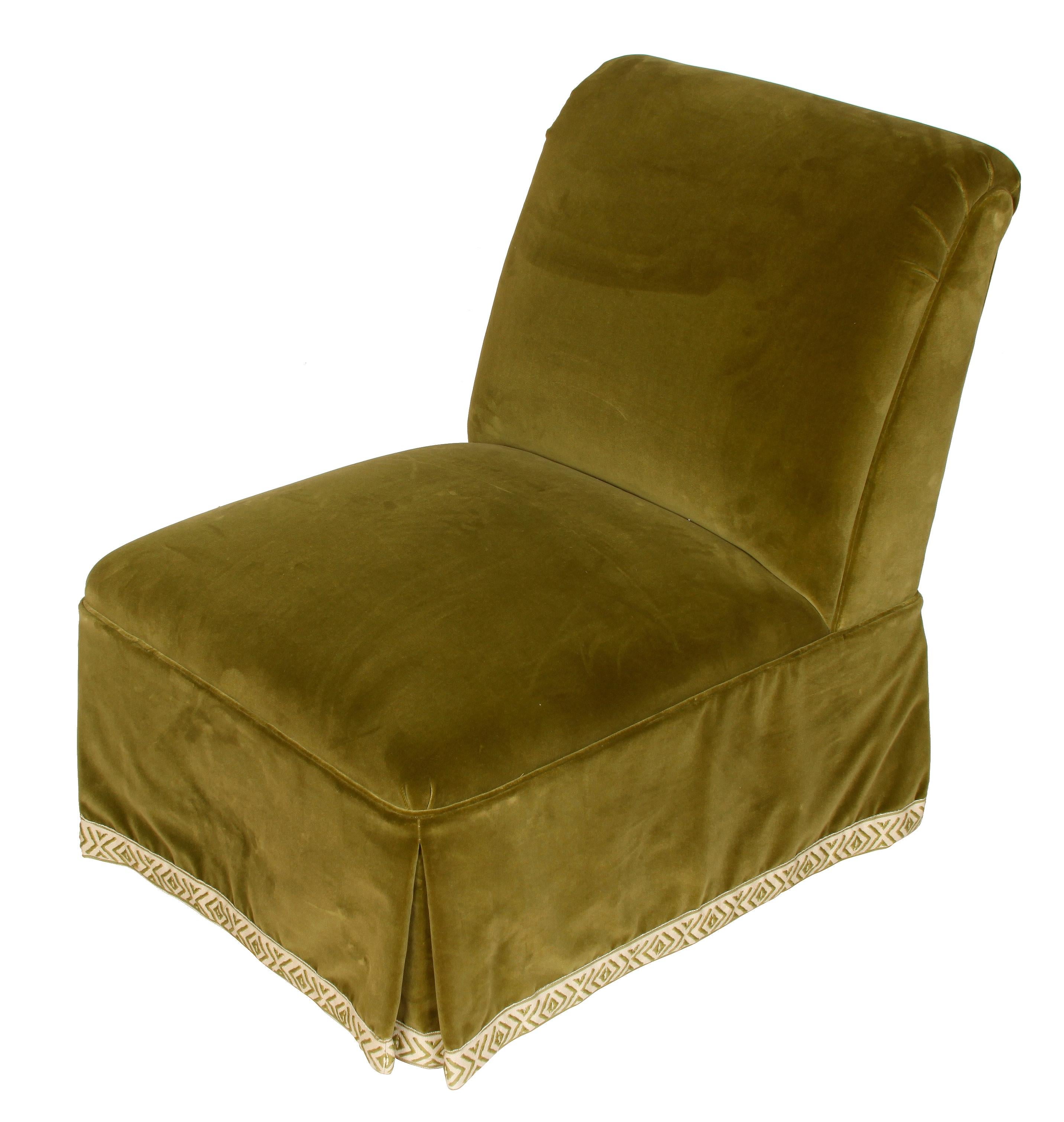 A pair of green velvet slipper chairs with diamond design tape trim, beautifully upholstered.