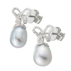 A pair of grey cultured pear and diamond bow earrings