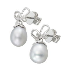A pair of grey cultured pear and diamond bow earrings