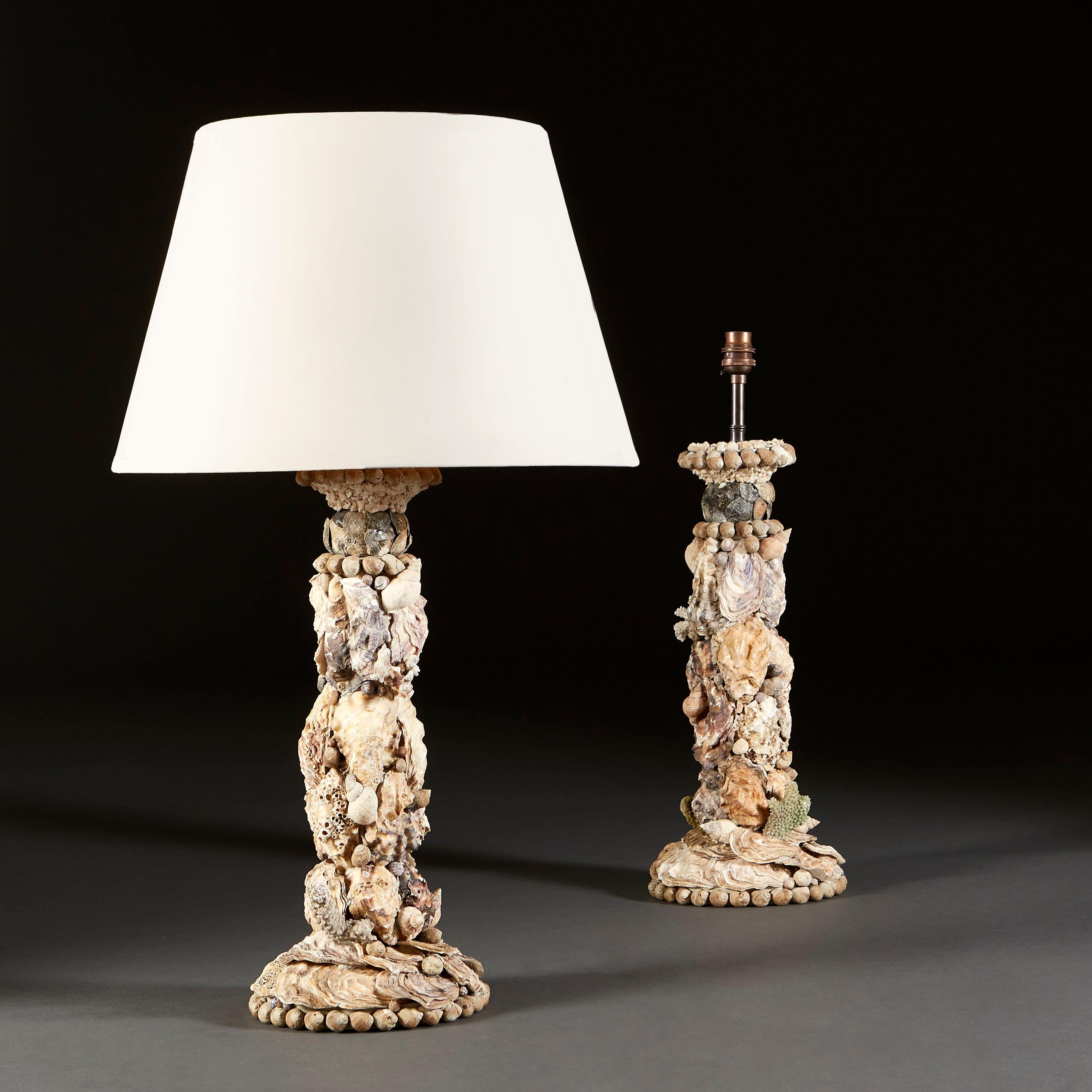 A pair of shell encrusted grotto lamps, incorporating oyster shells and conch shells, by Tess Morley.

Currently wired for the UK.

Please note: Lampshades not included.
