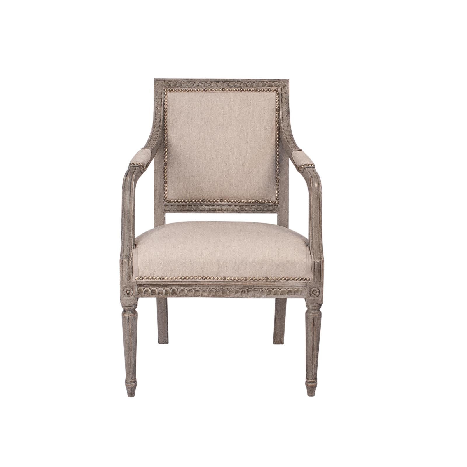 A pair of Swedish Gustavian Style painted armchairs, circa 1890. In later grey paint with refreshed upholstery. The carving is particularly good. A Classic design that would look good in most interiors.