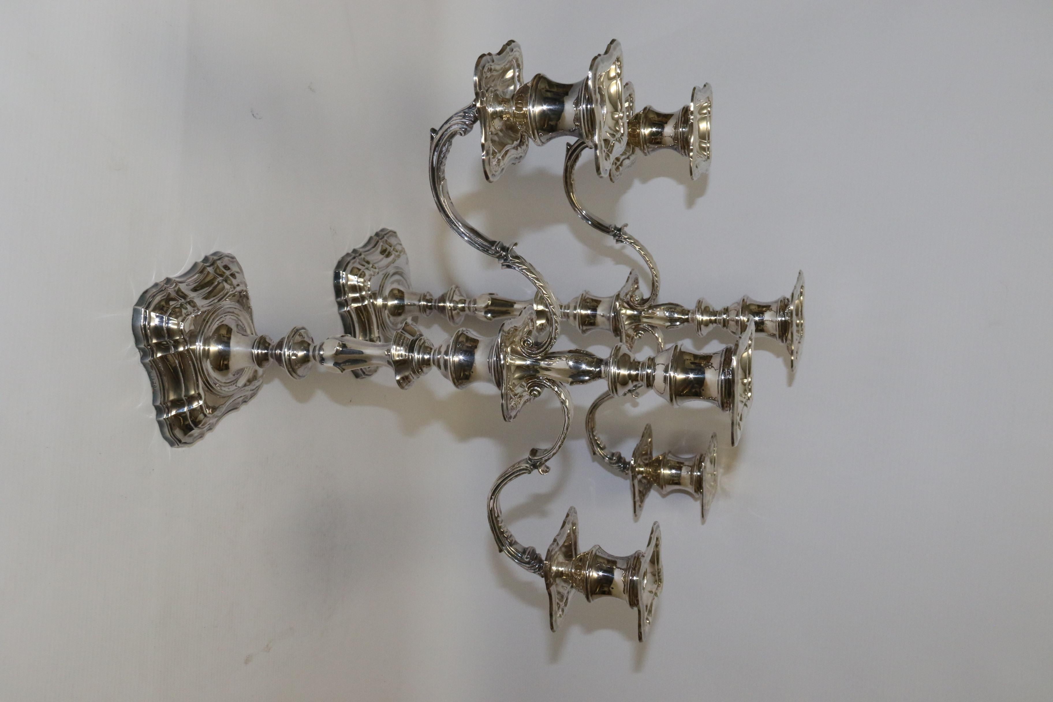 This impressive pair of fine quality silver candelabra are beautifully made in an early Georgian style. They were manufactured in Sheffield by the renowned silversmith Roberts and Belk who was established in 1892 and well known for making a large