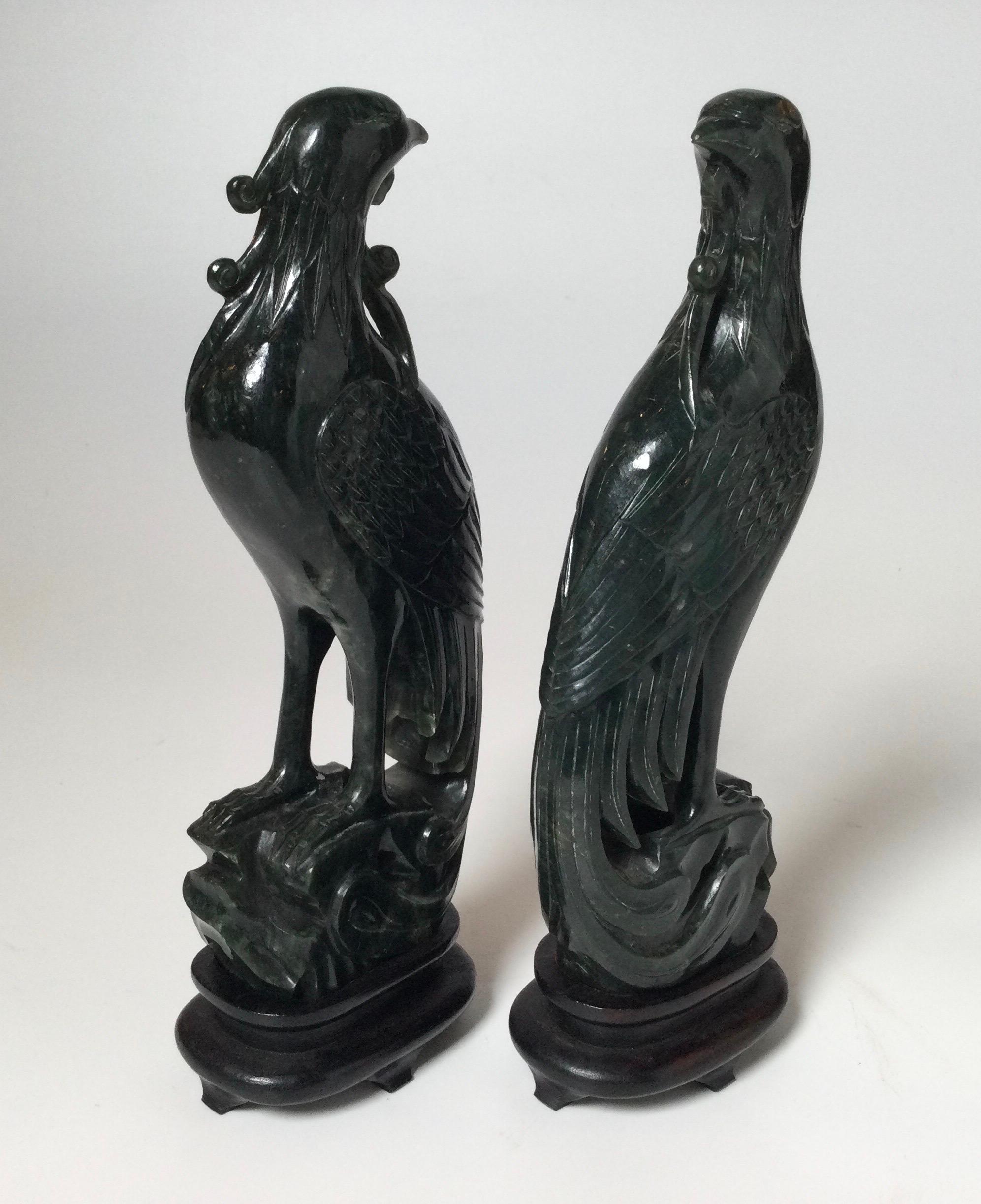 A pair of lovely late 19th / early 20th century hand carved had phoenix bird sculptures with original custom wood bases. The spinach jade is a deep rich jade green without stands measure 8 inches tall, 9.25 inches tall with stands.